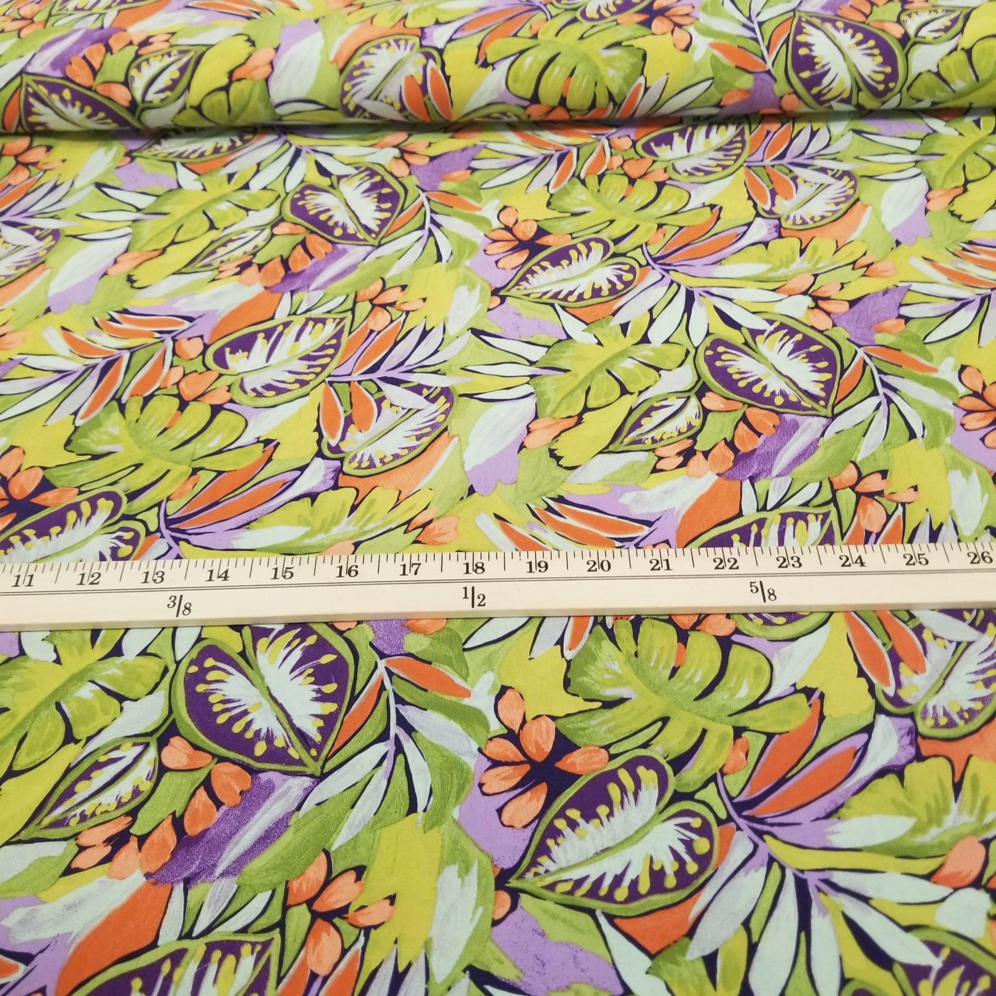 Colorful tropical leaf pattern fabric with a ruler for scale