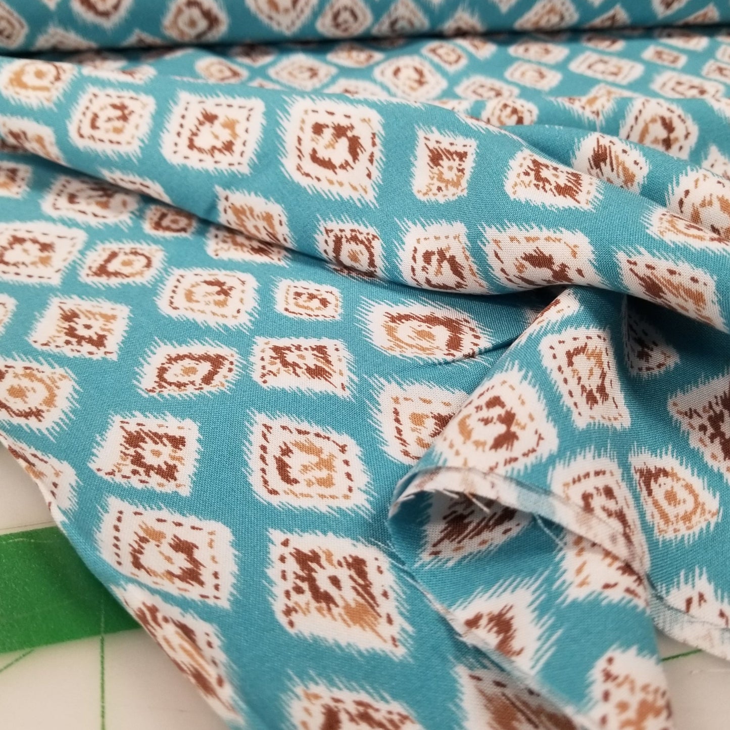 Close-up of fabric with a diamond pattern on a blue background