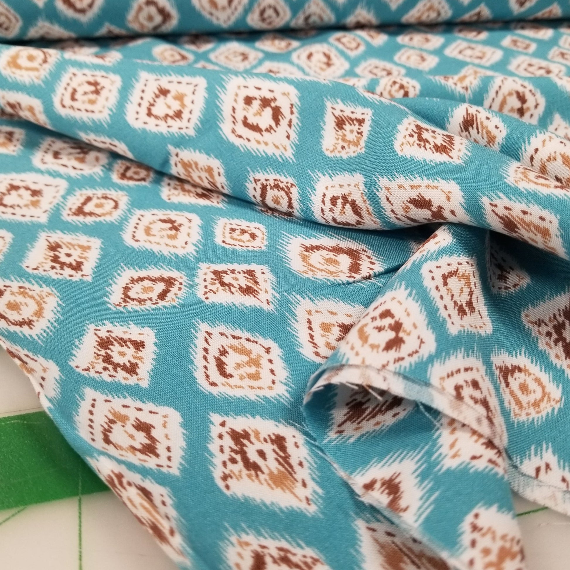 Close-up of fabric with a diamond pattern on a blue background