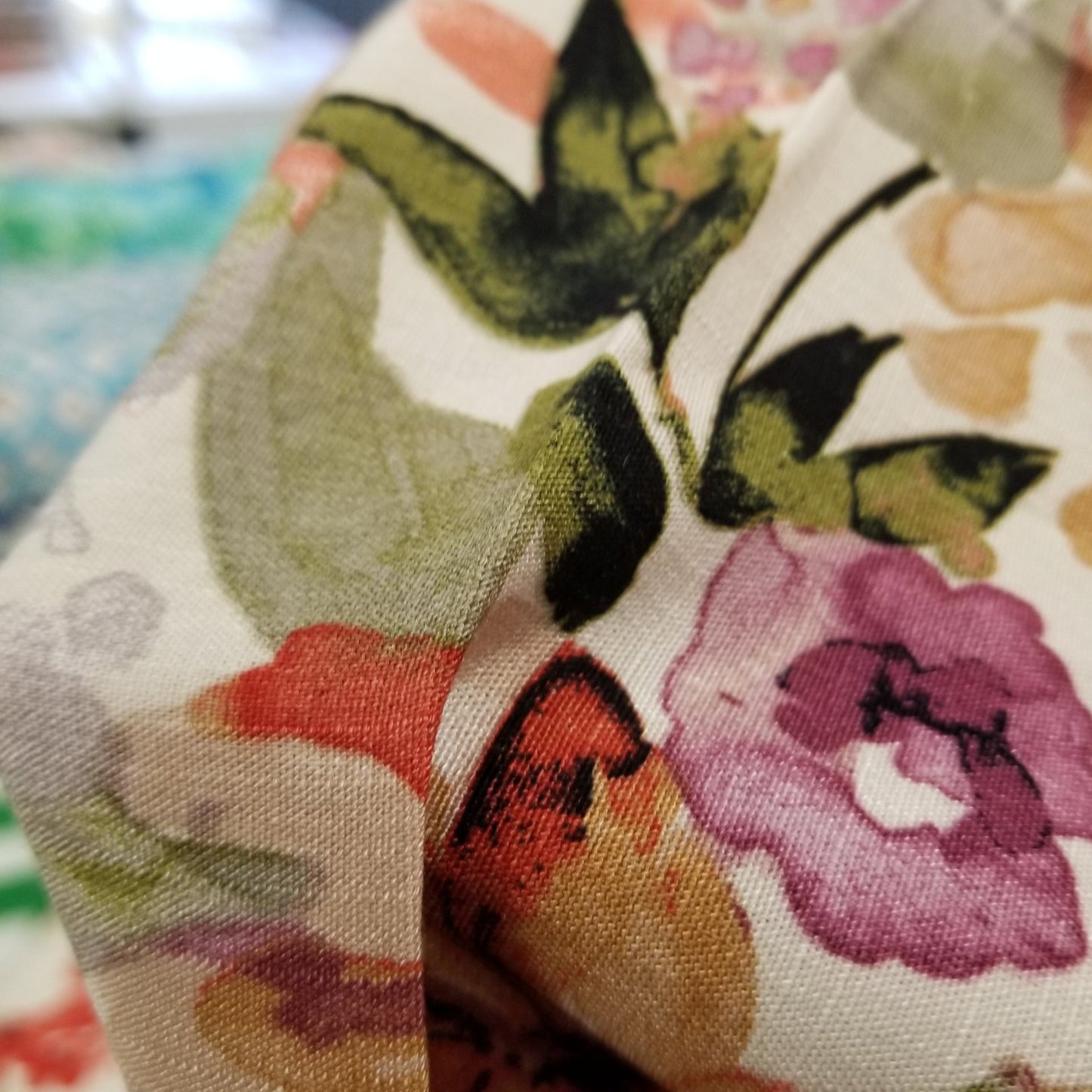 Floral patterned fabric with colorful flowers on a neutral background