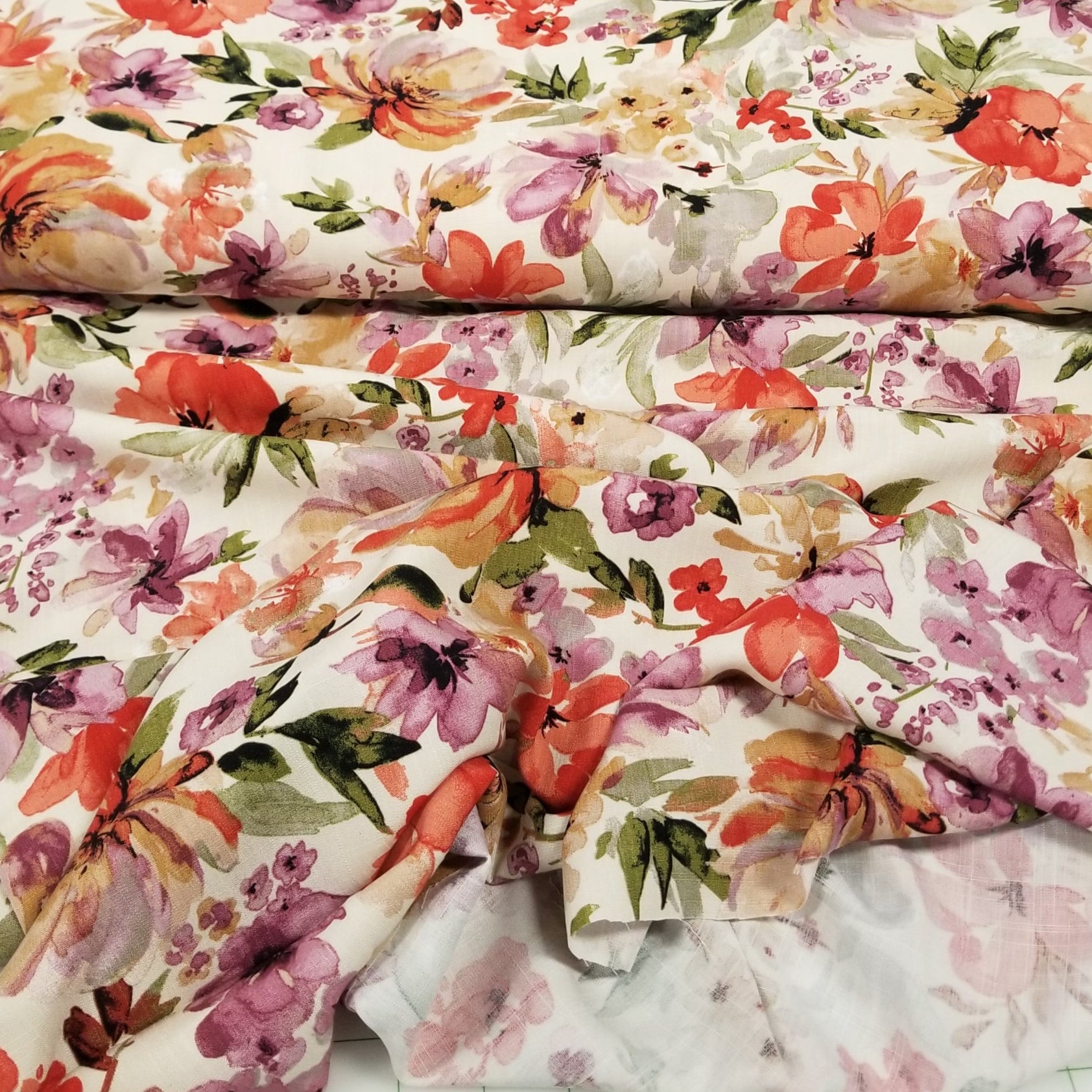 Floral fabric swatches arranged on a grid background