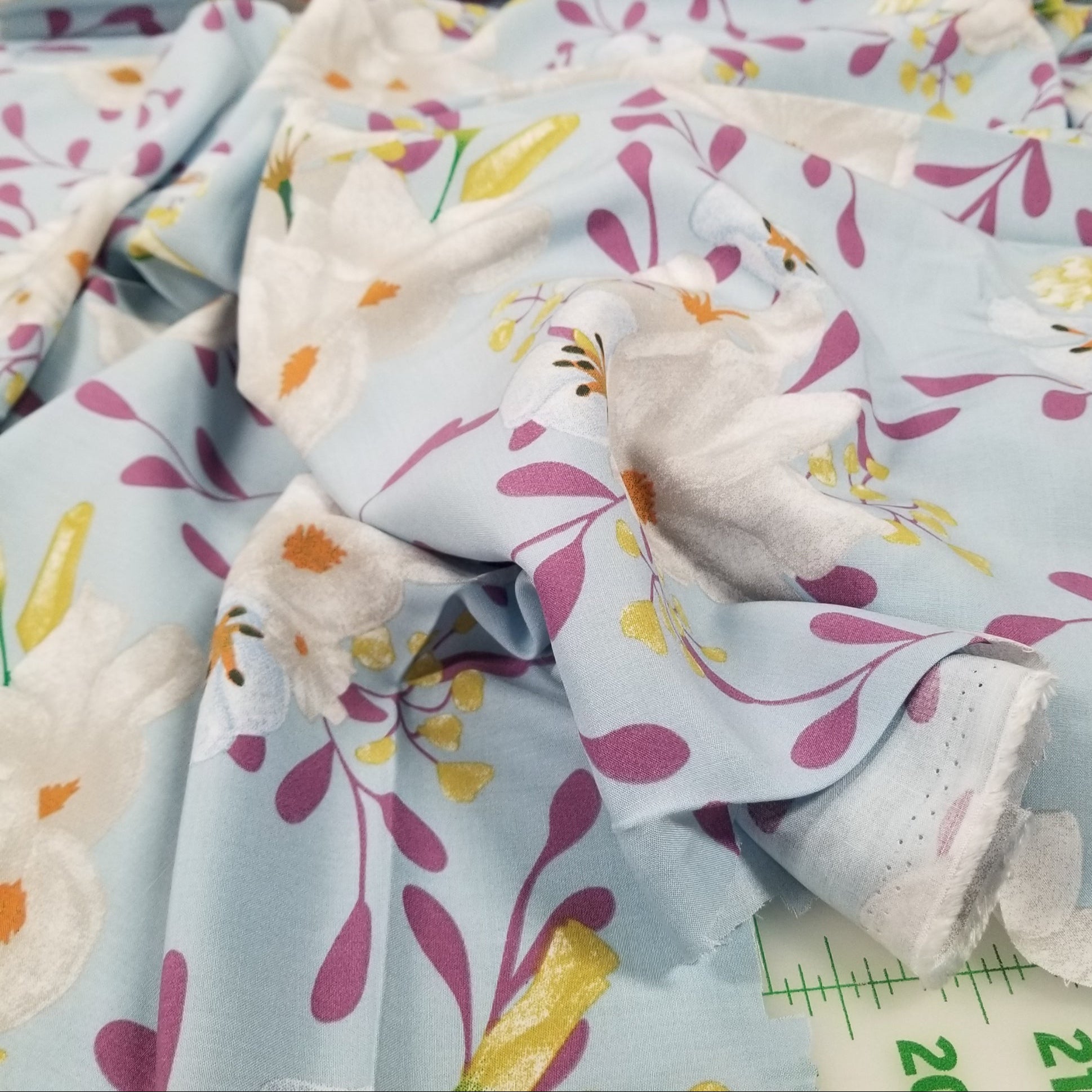 Floral-patterned fabric with a focus on a white dove design.