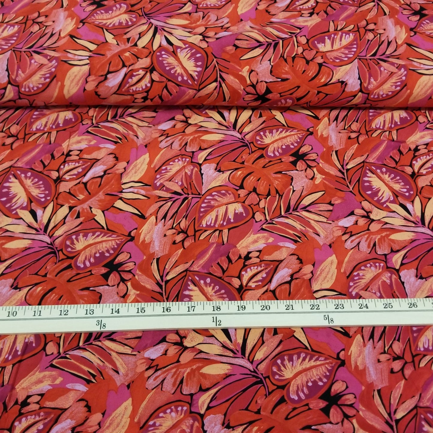 Fiberglass fabric with red and pink leaf pattern, measured by a ruler.