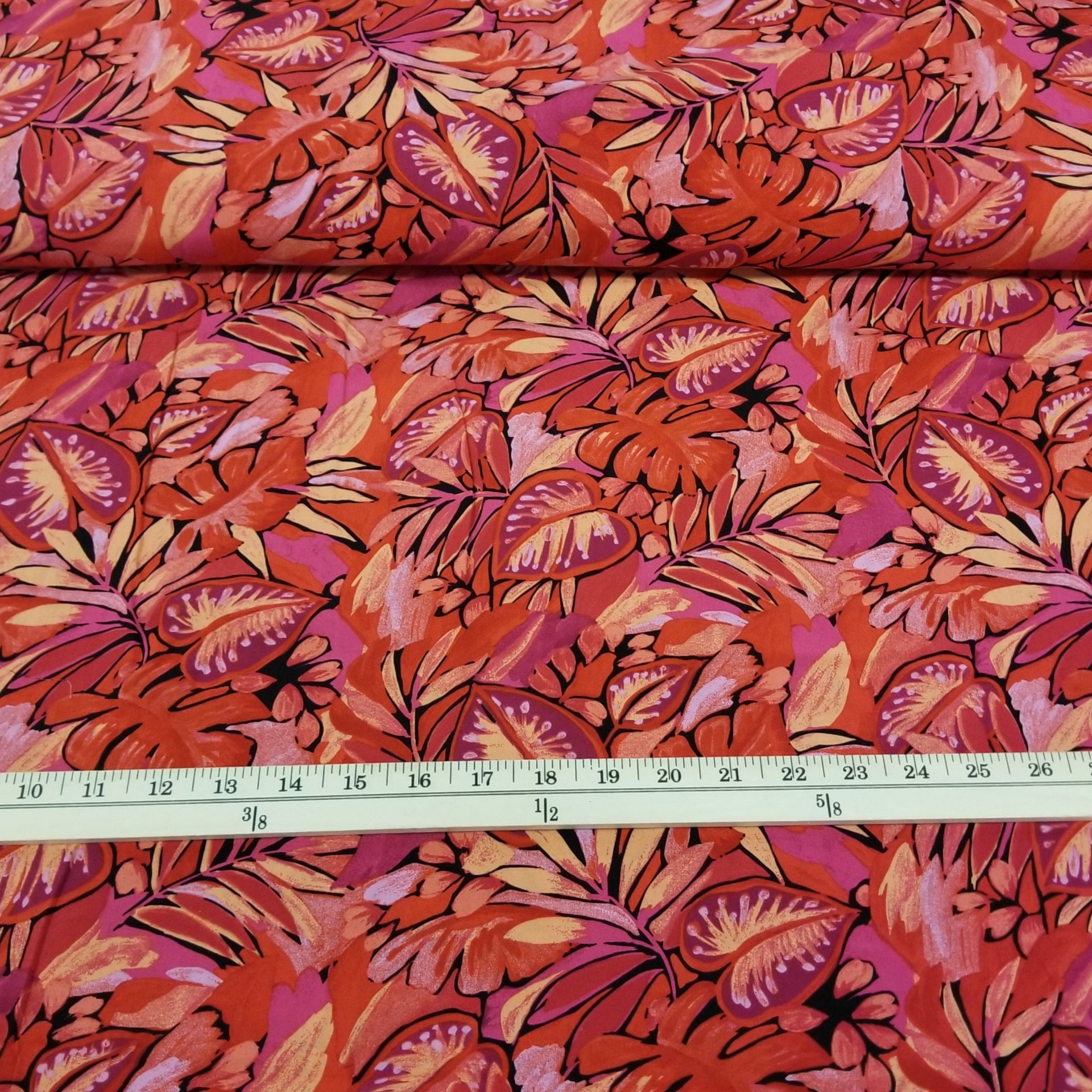 Fiberglass fabric with red and pink leaf pattern, measured by a ruler.