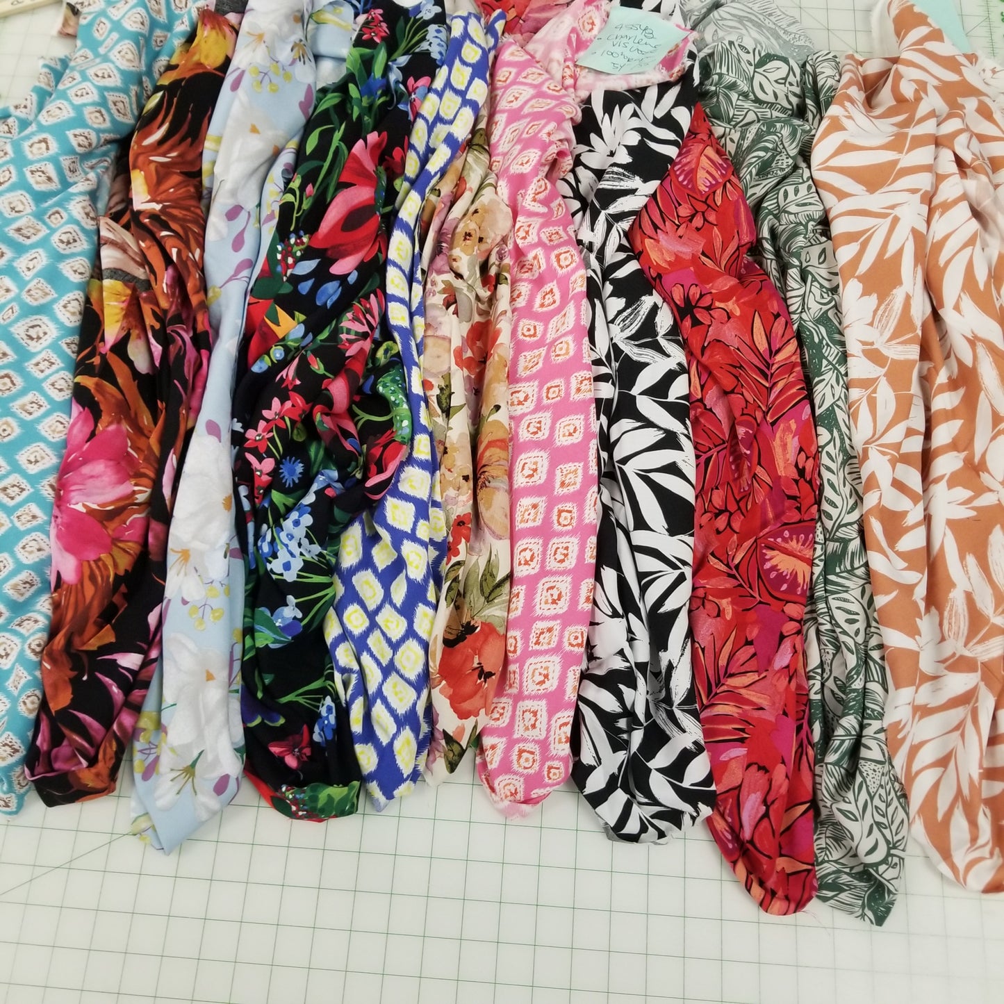 Stack of colorful fabric strips on a grid background