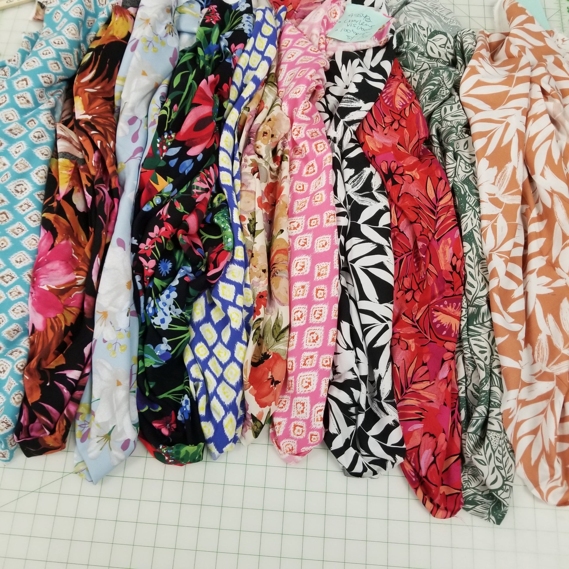 Stack of colorful fabric strips on a grid background