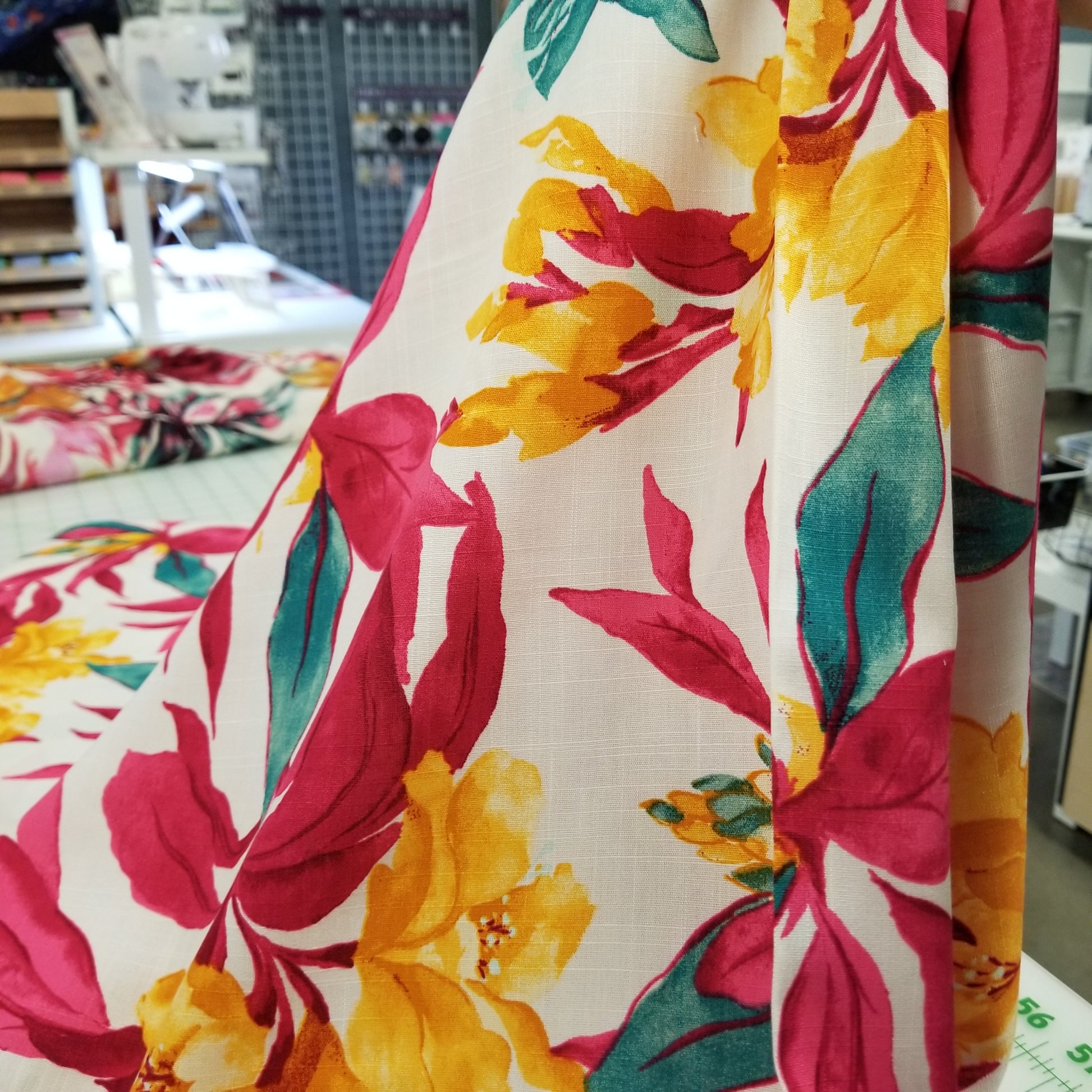 Close-up of colorful floral fabric with a blurred indoor background