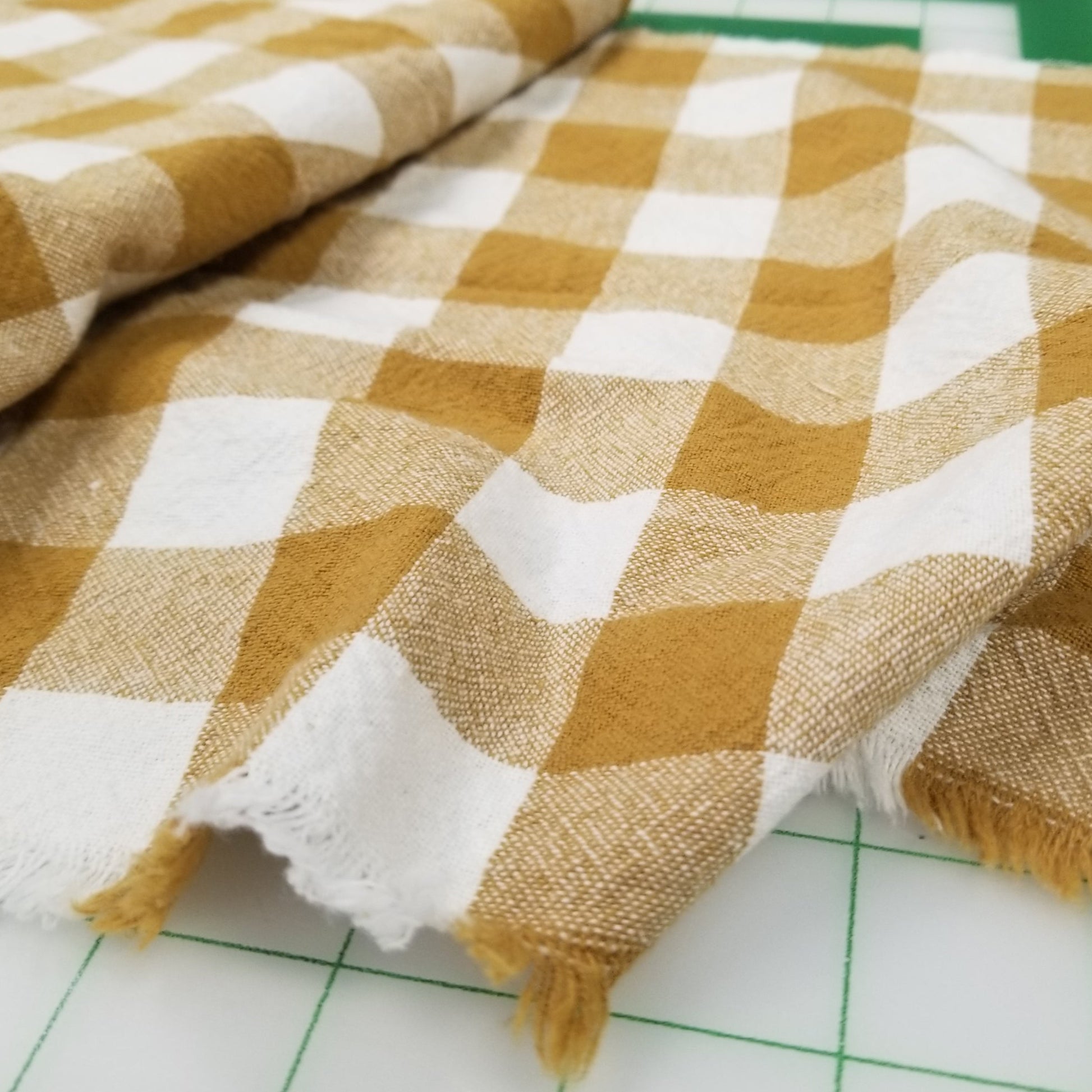 Checkered fabric with yellow and white pattern on a grid background