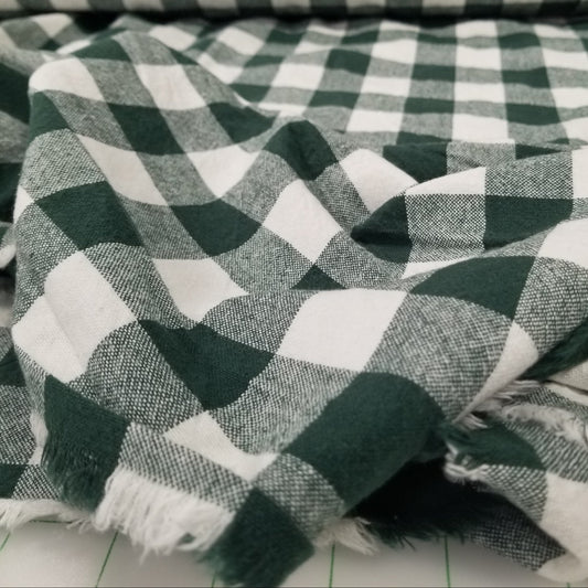 Green and white checkered scarf with a blurred background
