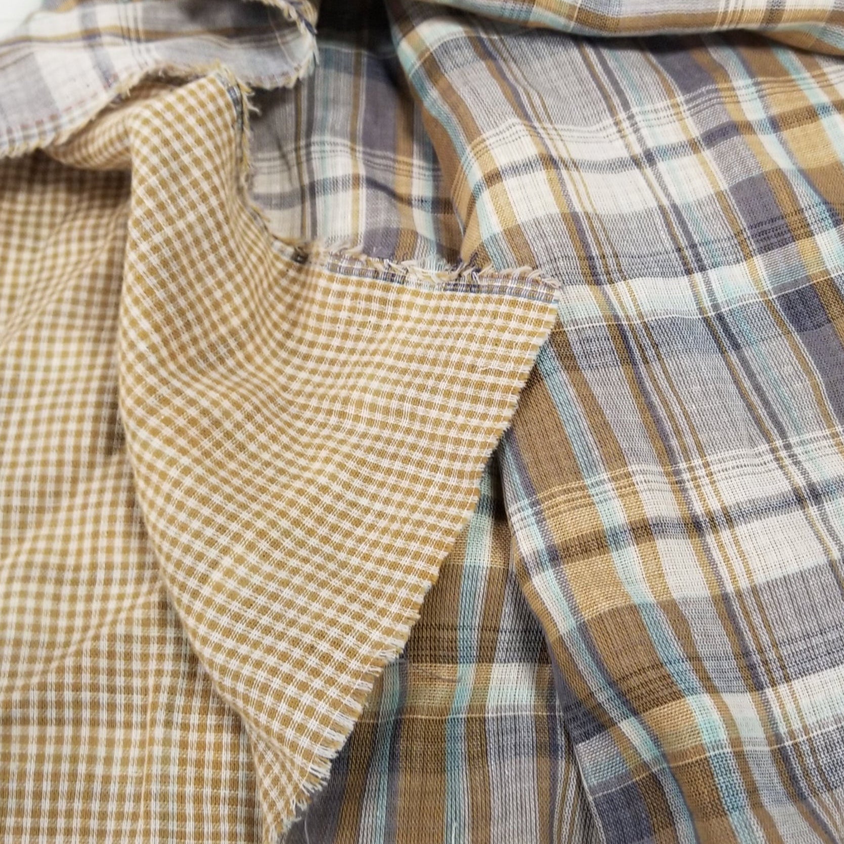 Plaid and checkered fabric pieces on a white background