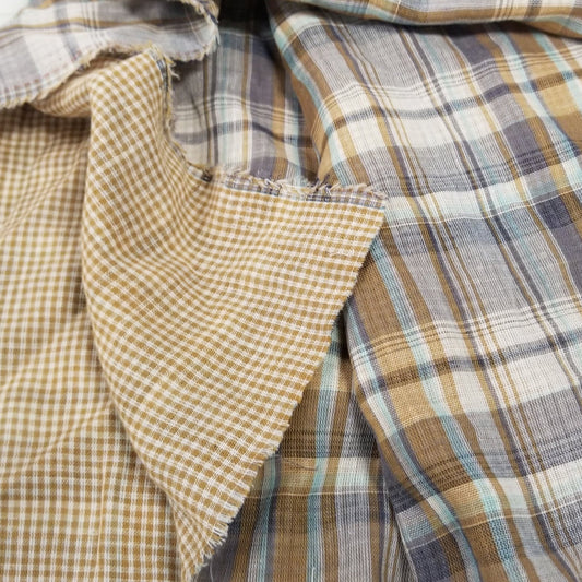 Plaid and checkered fabric pieces on a white background