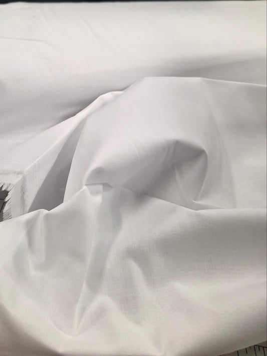 White fabric with frayed edges on a tiled floor