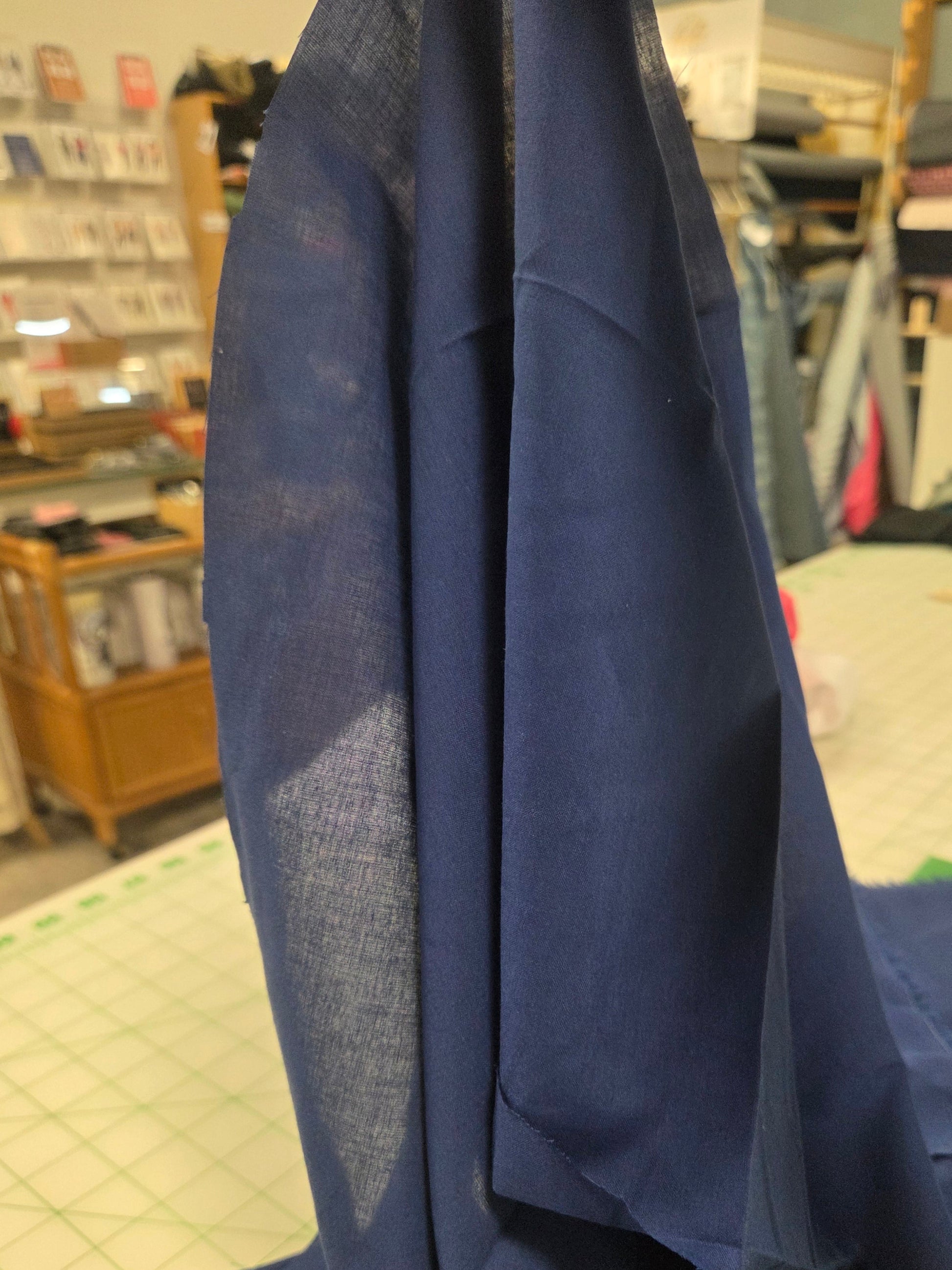 Close-up of a blue fabric with a blurred indoor background
