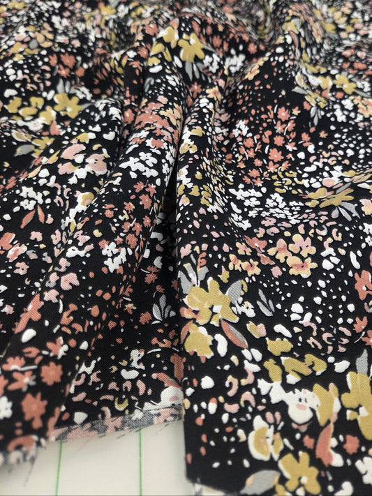 Floral patterned fabric with black background. LA FInch Fabrics rayon challis by the yard