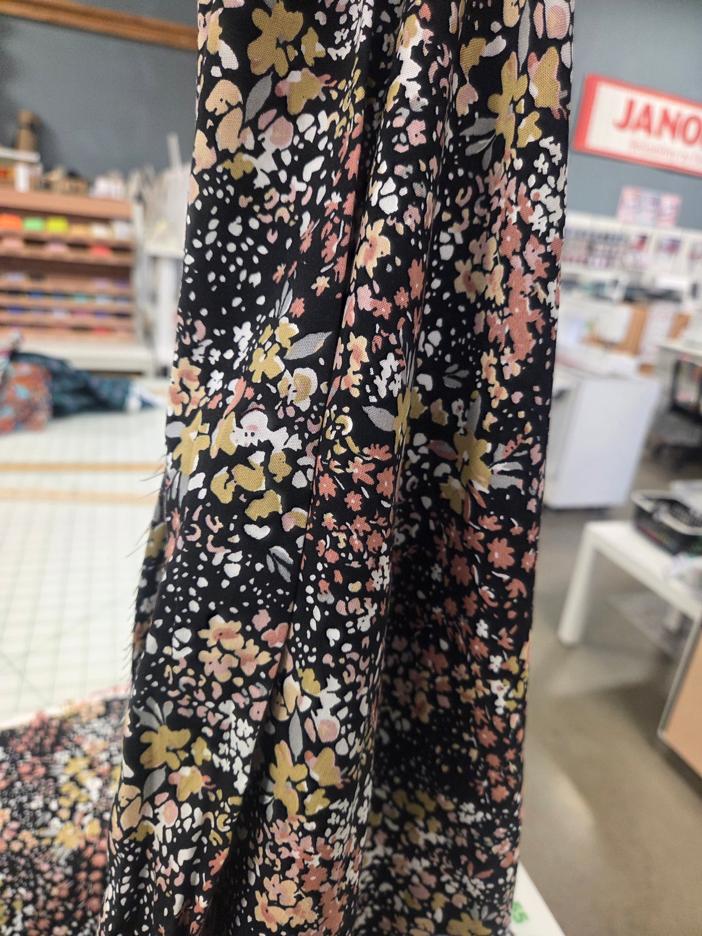 Floral patterned fabric with black background in a store setting