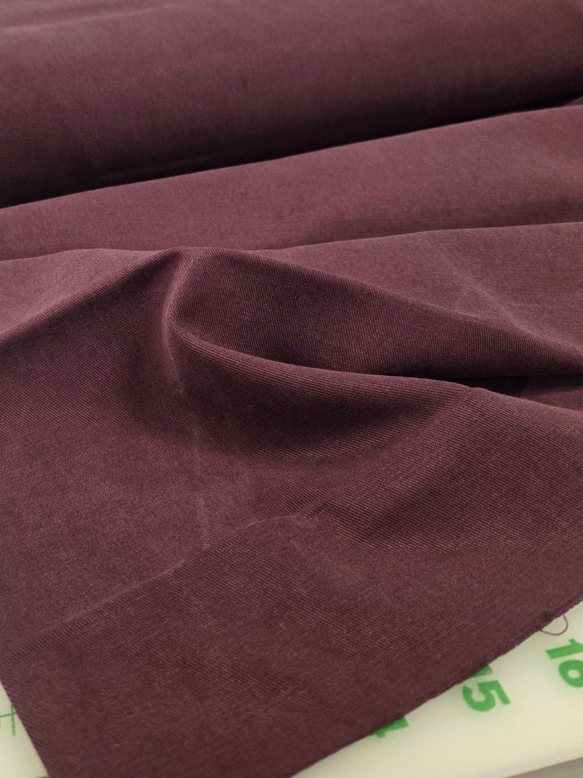 Brown fabric on a cutting mat with measurements in the background