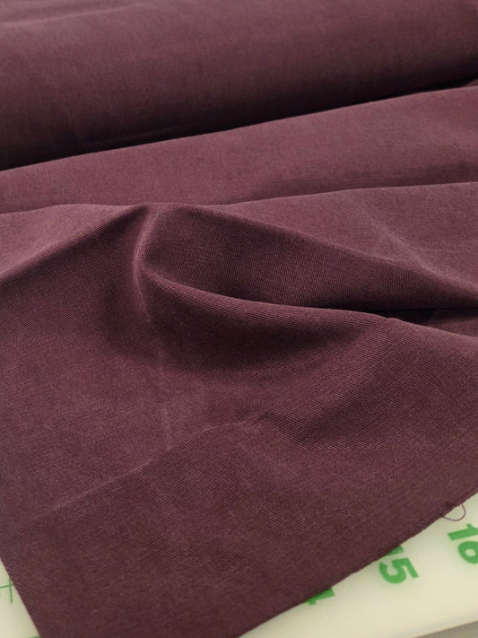 Brown fabric on a cutting mat with measurements in the background