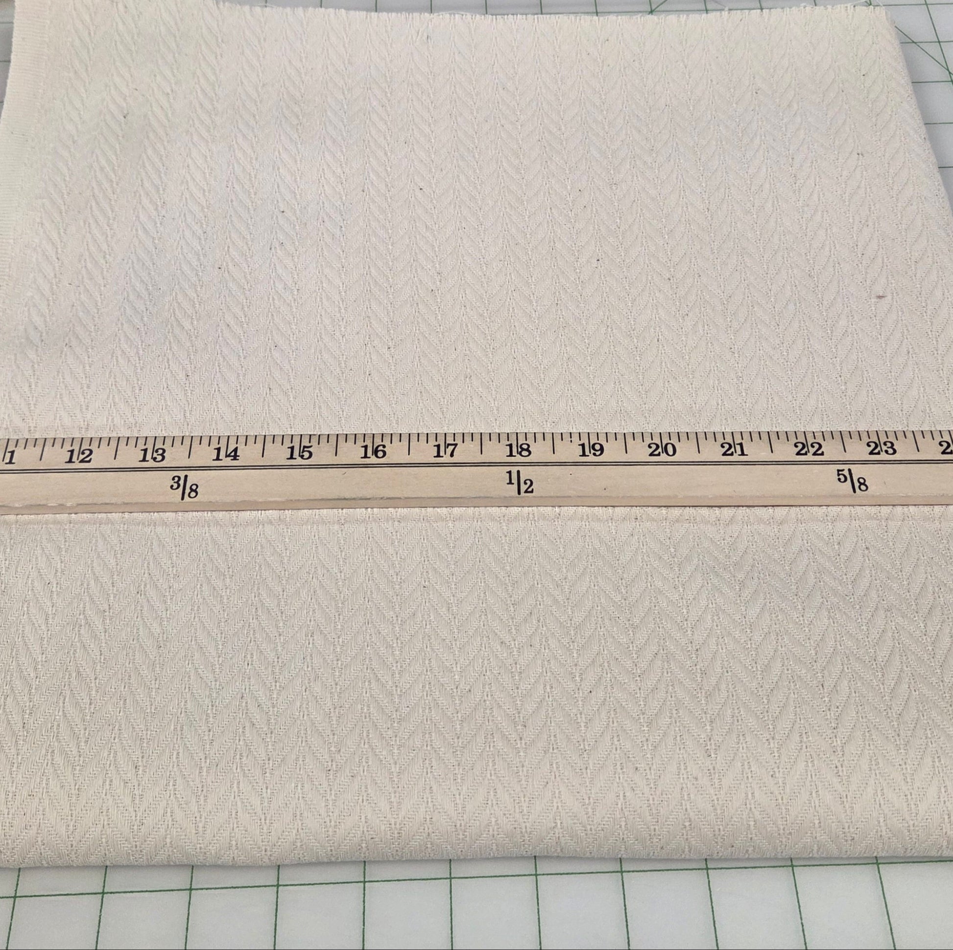 Beige fabric with a ruler on a grid background. LA Finch Fabric