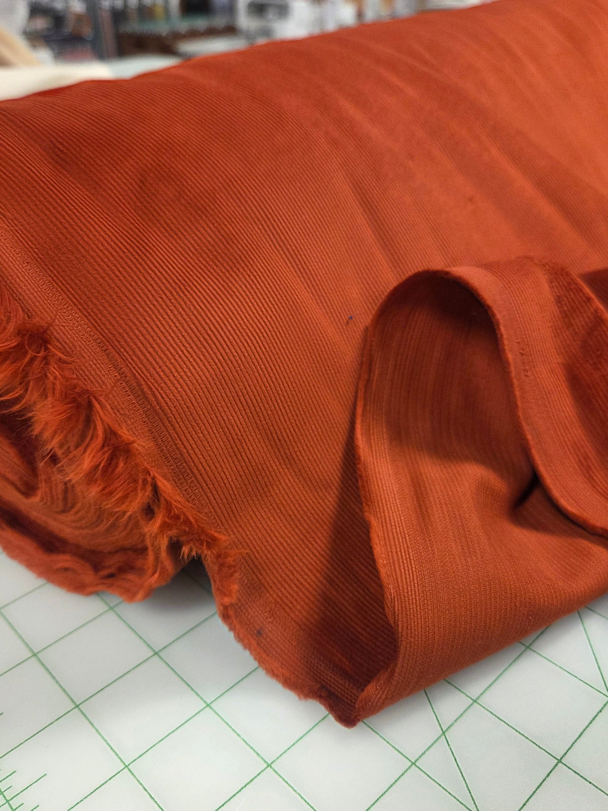 Brown fabric on a cutting mat with grid lines