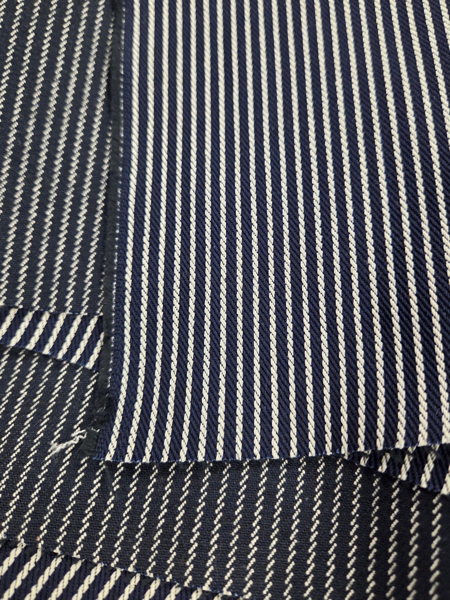 Close-up of navy and white striped fabric. Cone Mills Denim