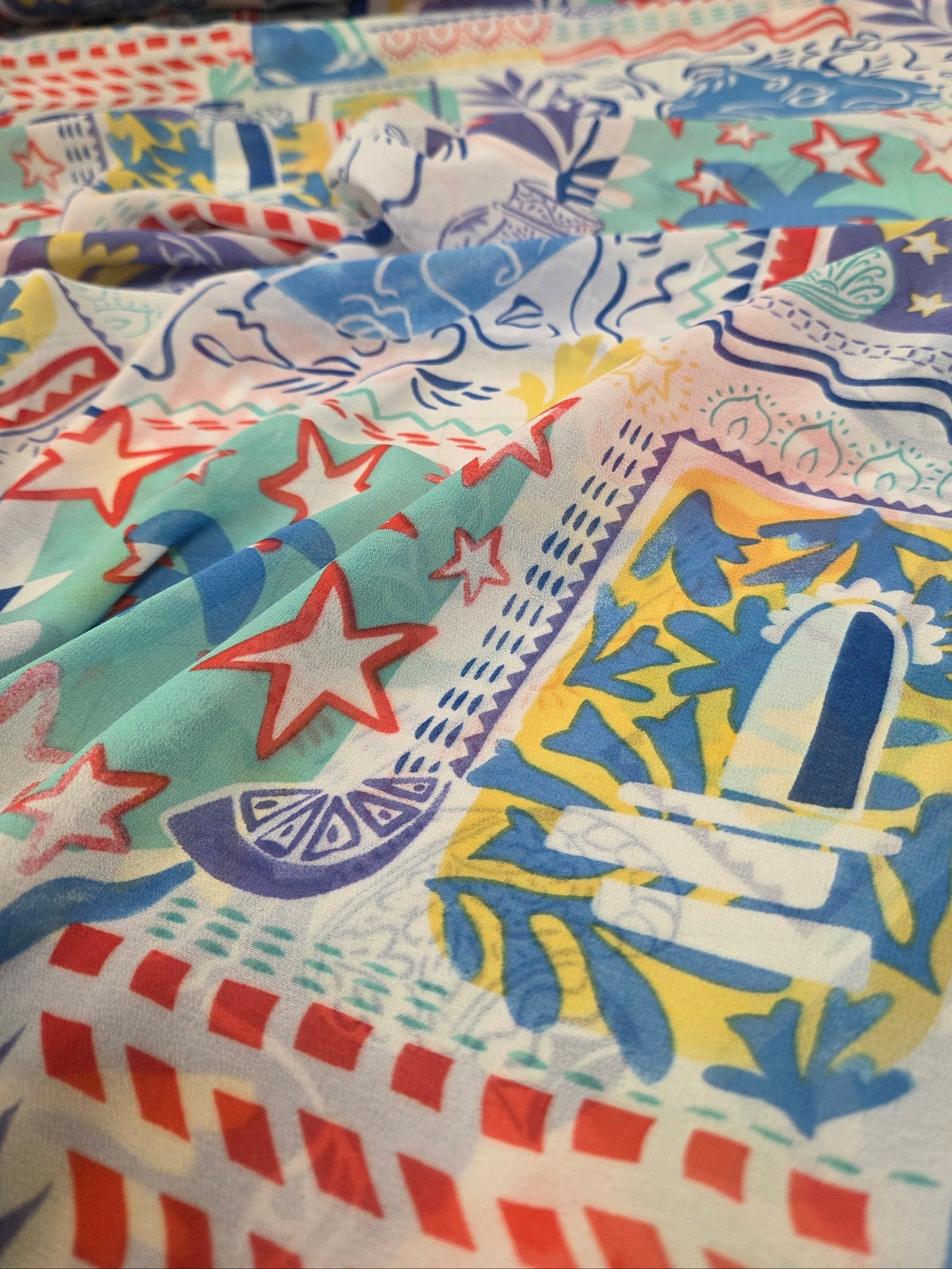 Colorful fabric with various patterns including stars and geometric shapes.
