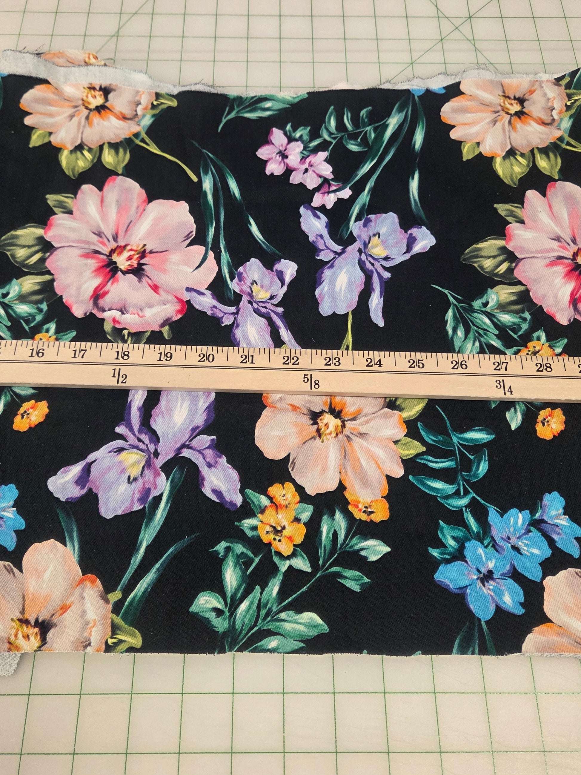 Floral fabric on a cutting mat with a ruler for measurement. LA Finch Fabrics.