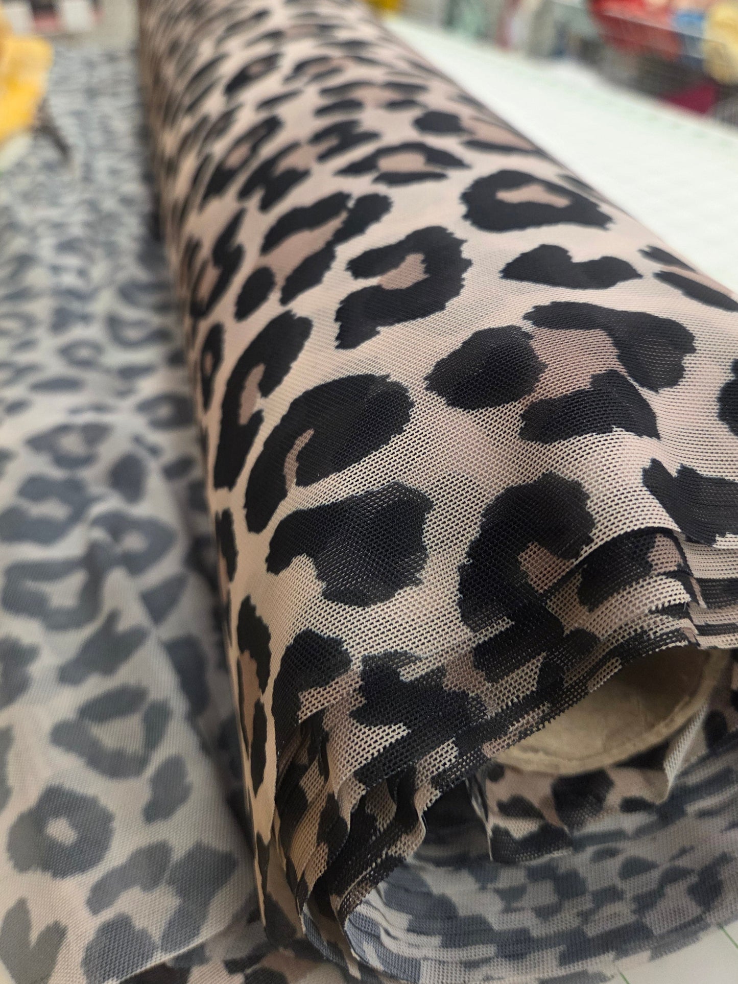 Leopard print bag on a surface with a blurred background. Fashon fabric Shop in California. Animal Print Mesh Knit