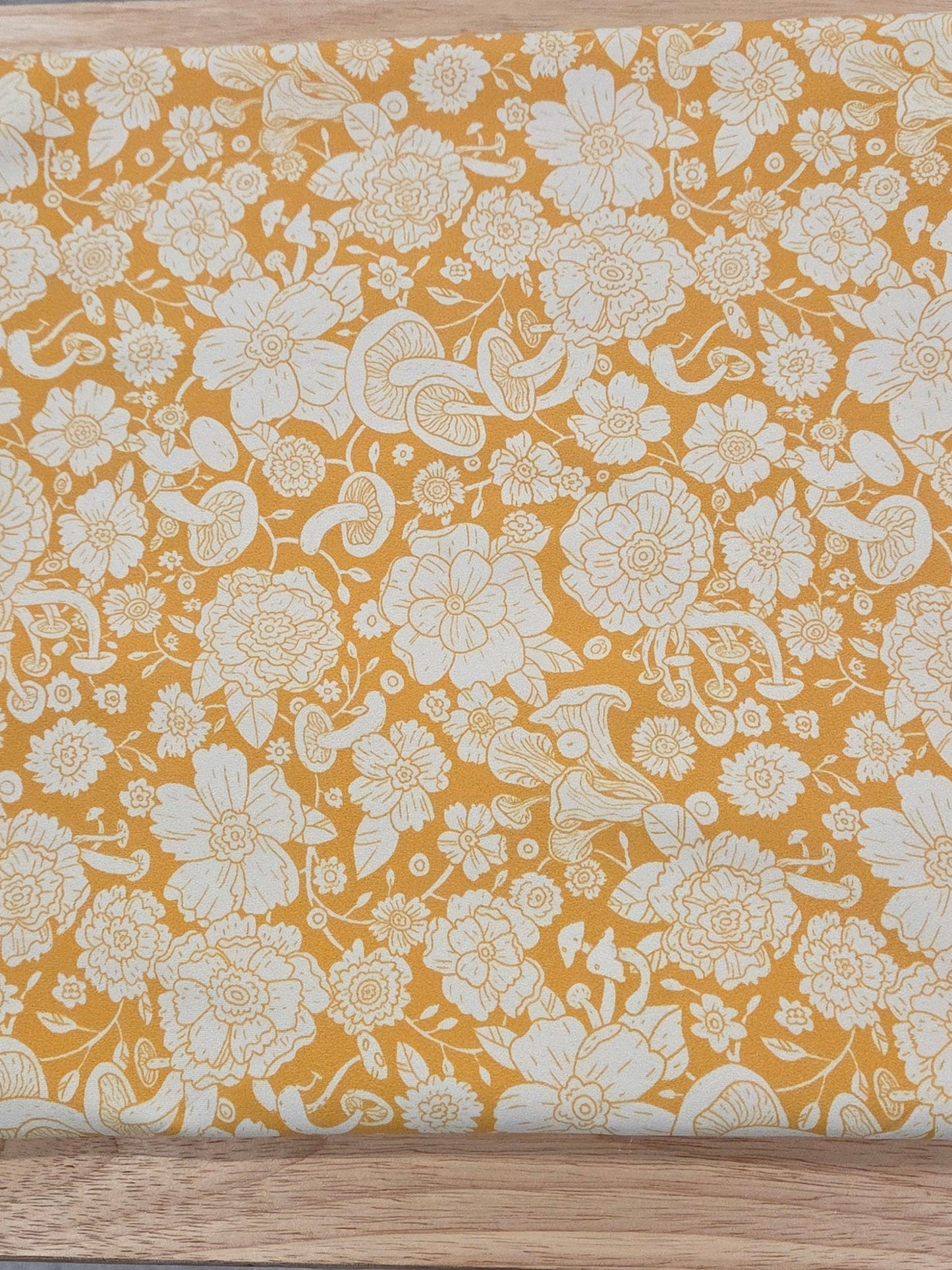 Floral-patterned wooden board on a gray surface