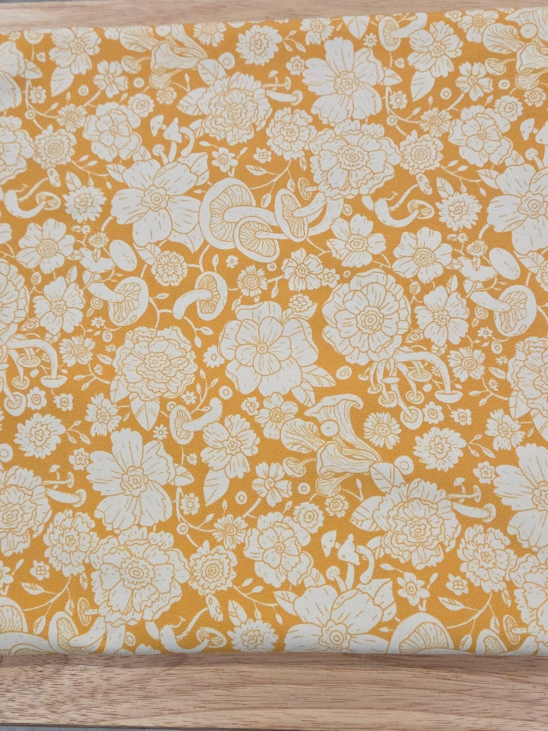 Floral-patterned wooden board on a gray surface