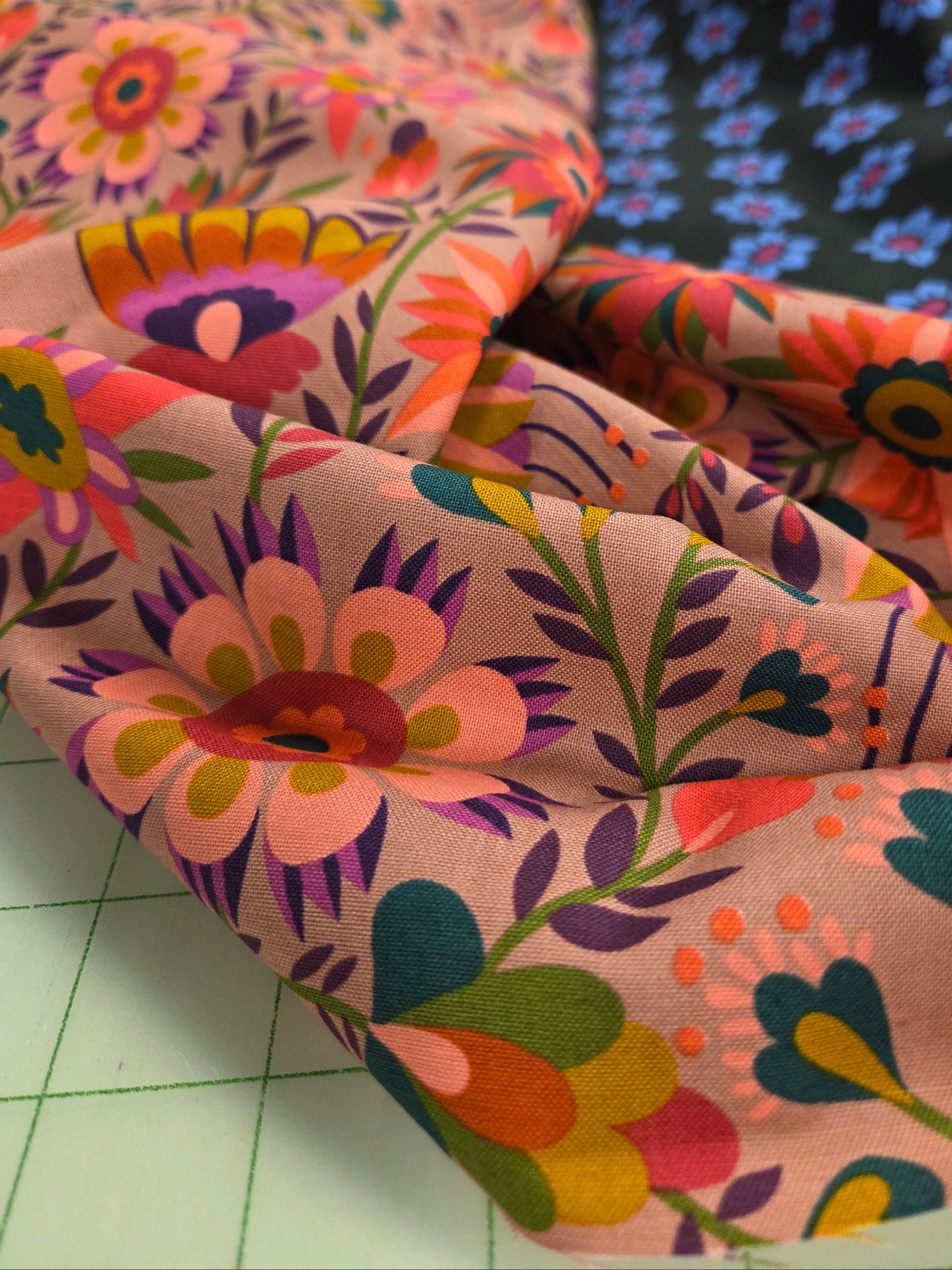 Colorful floral-patterned fabric on a tiled floor