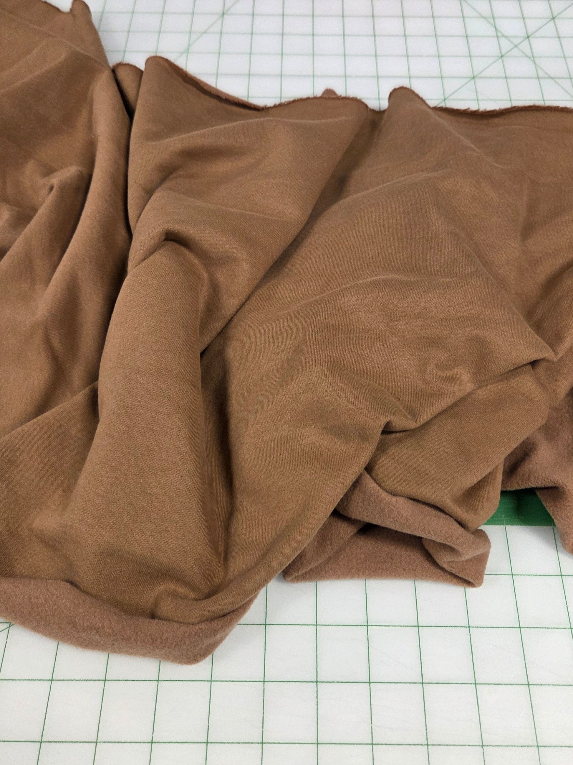 Brown fabric on a grid surface, sweatshirt fleece