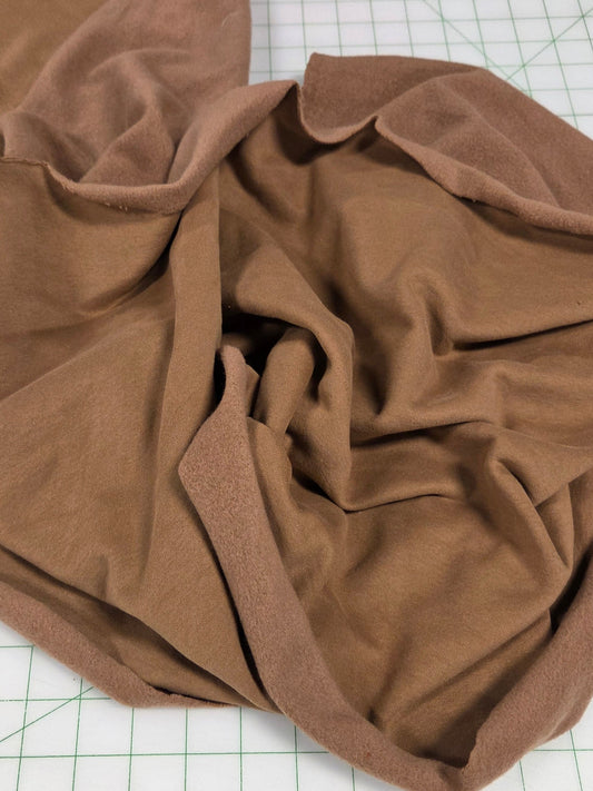 Brown fabric on a white grid surface