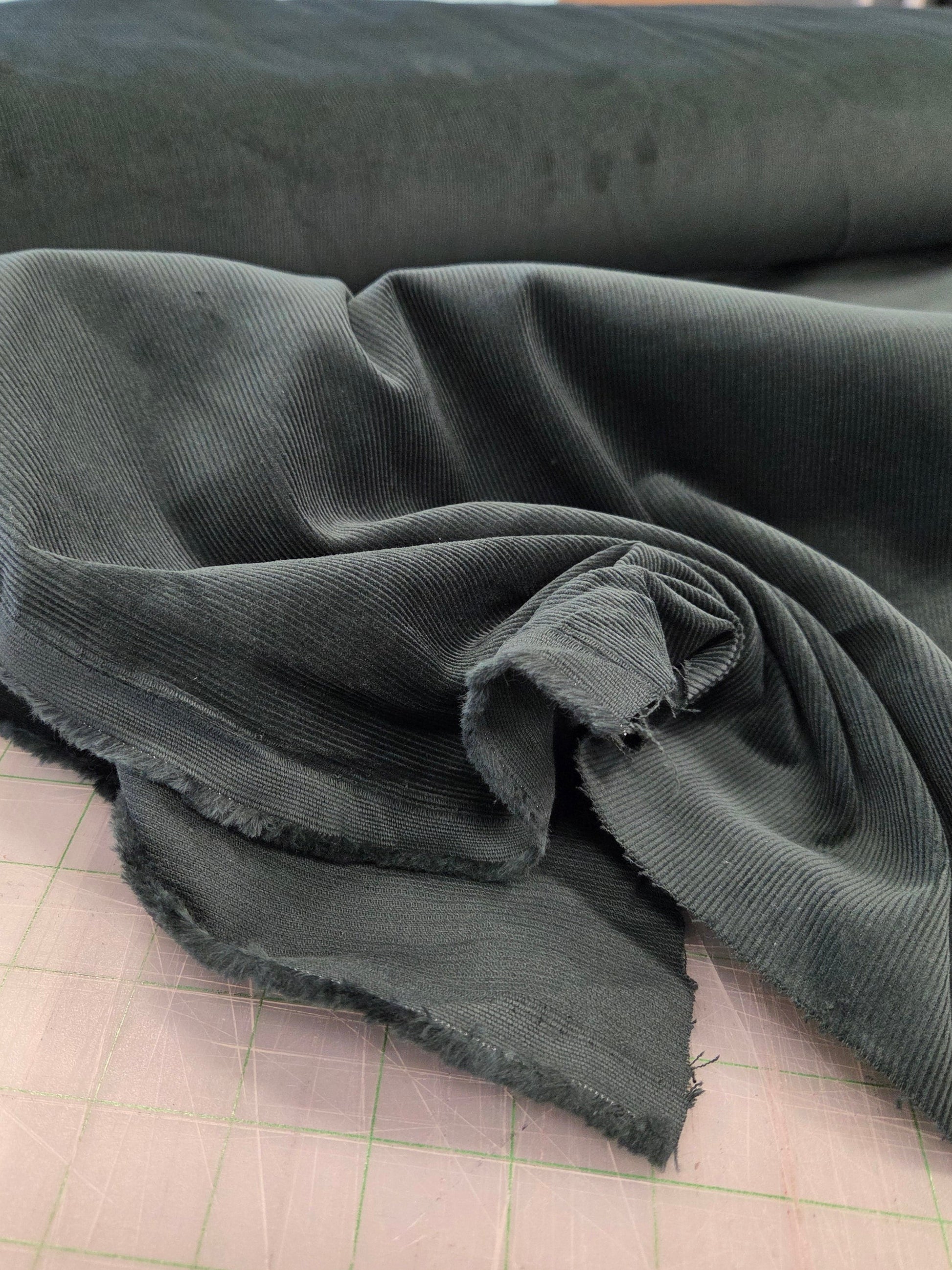 16 wale pine green corduroy cotton solid by the yard. LA Finch Fabrics for apparel fabrics