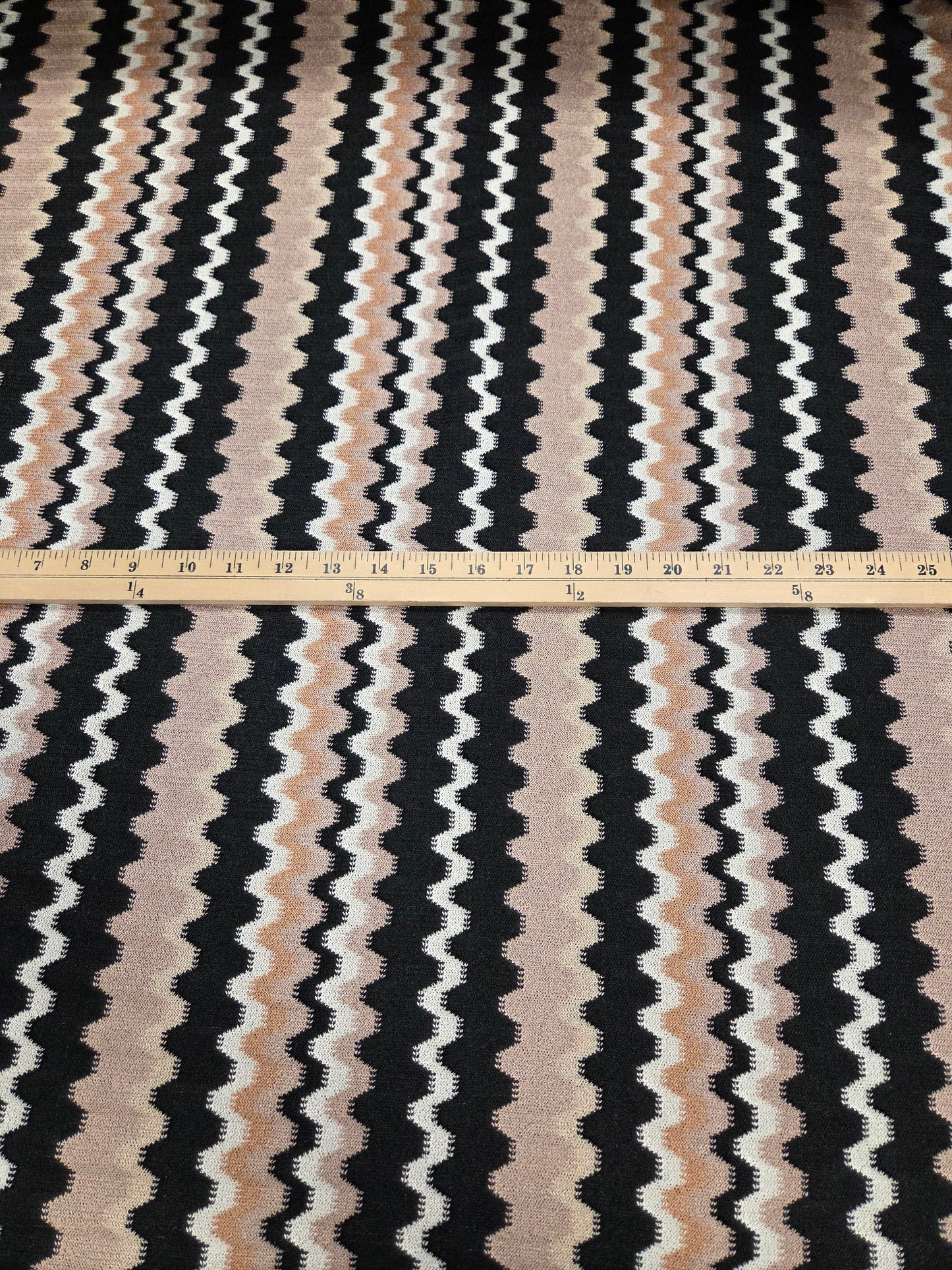 Textile with wavy black, white, and beige pattern