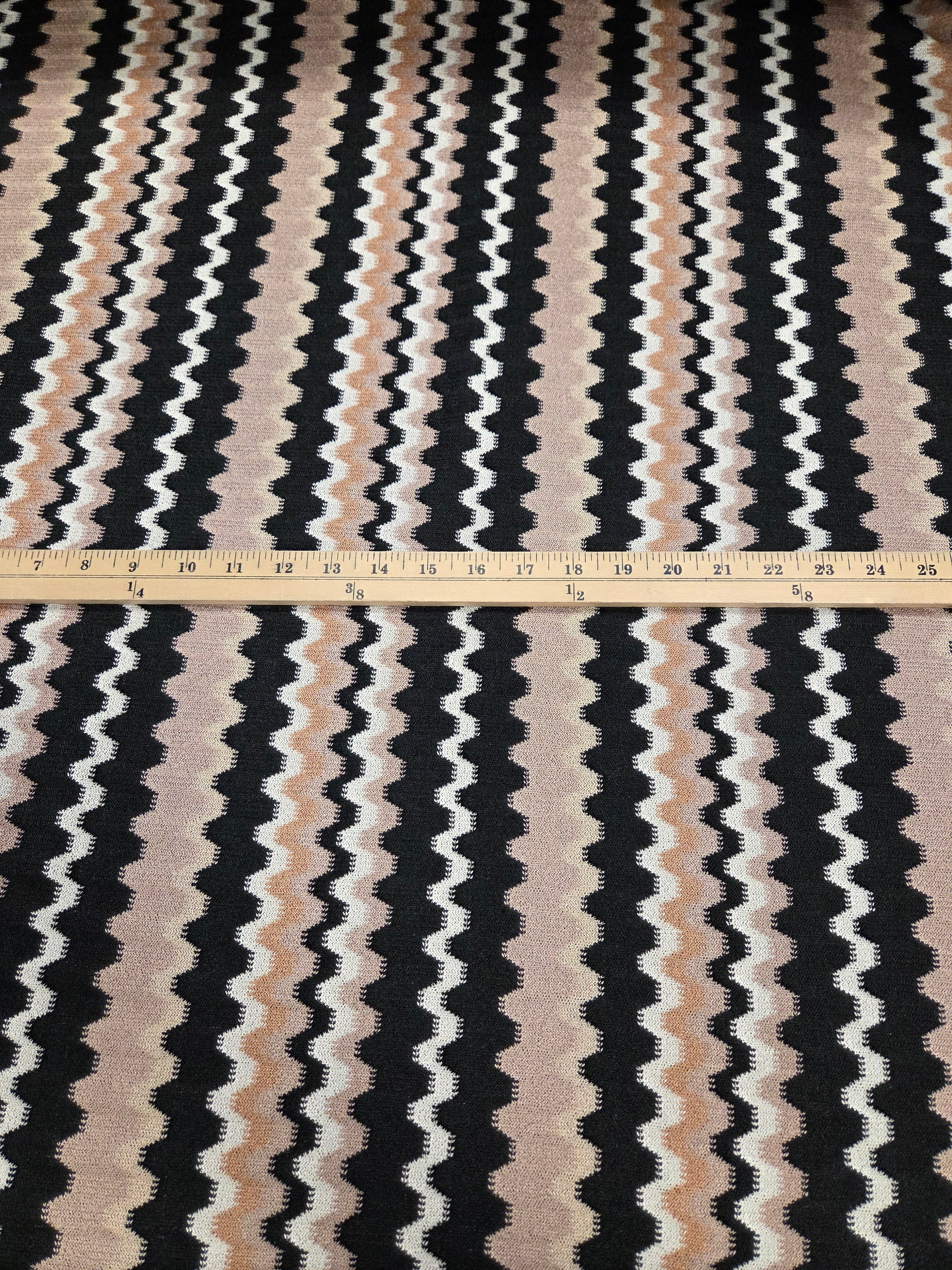 Textile with wavy black, white, and beige pattern