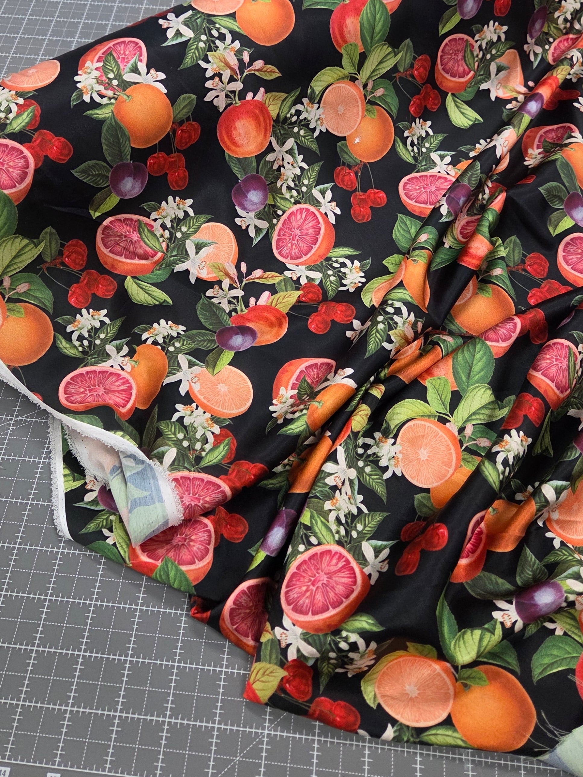 tropical fabric pattern with oranges and cherries woven. Stretch satin