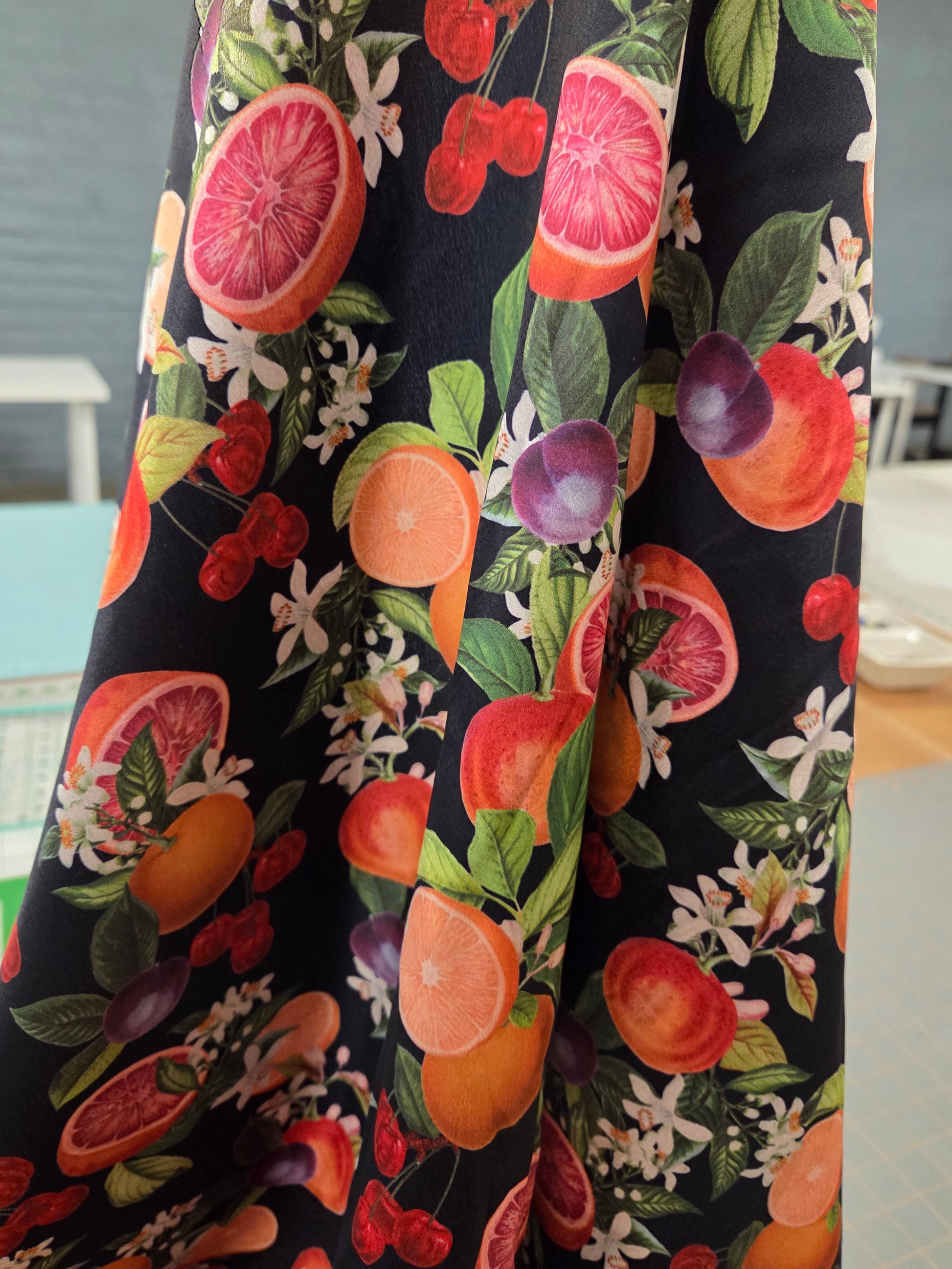 Fabric with a colorful fruit pattern on a black background