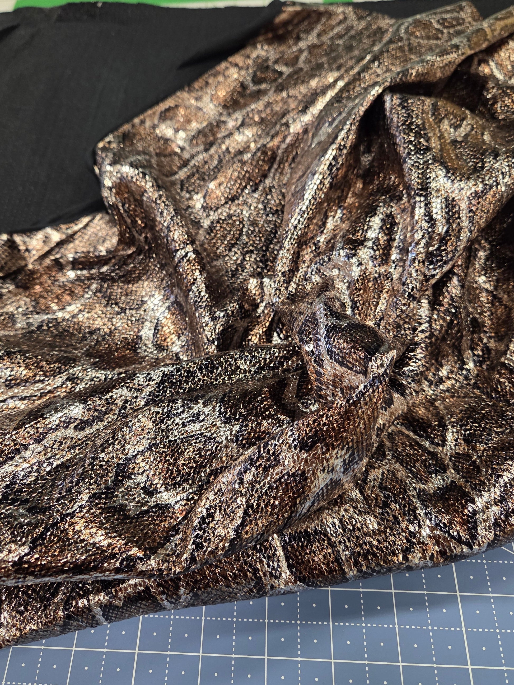 Textured fabric on a cutting mat with grid lines