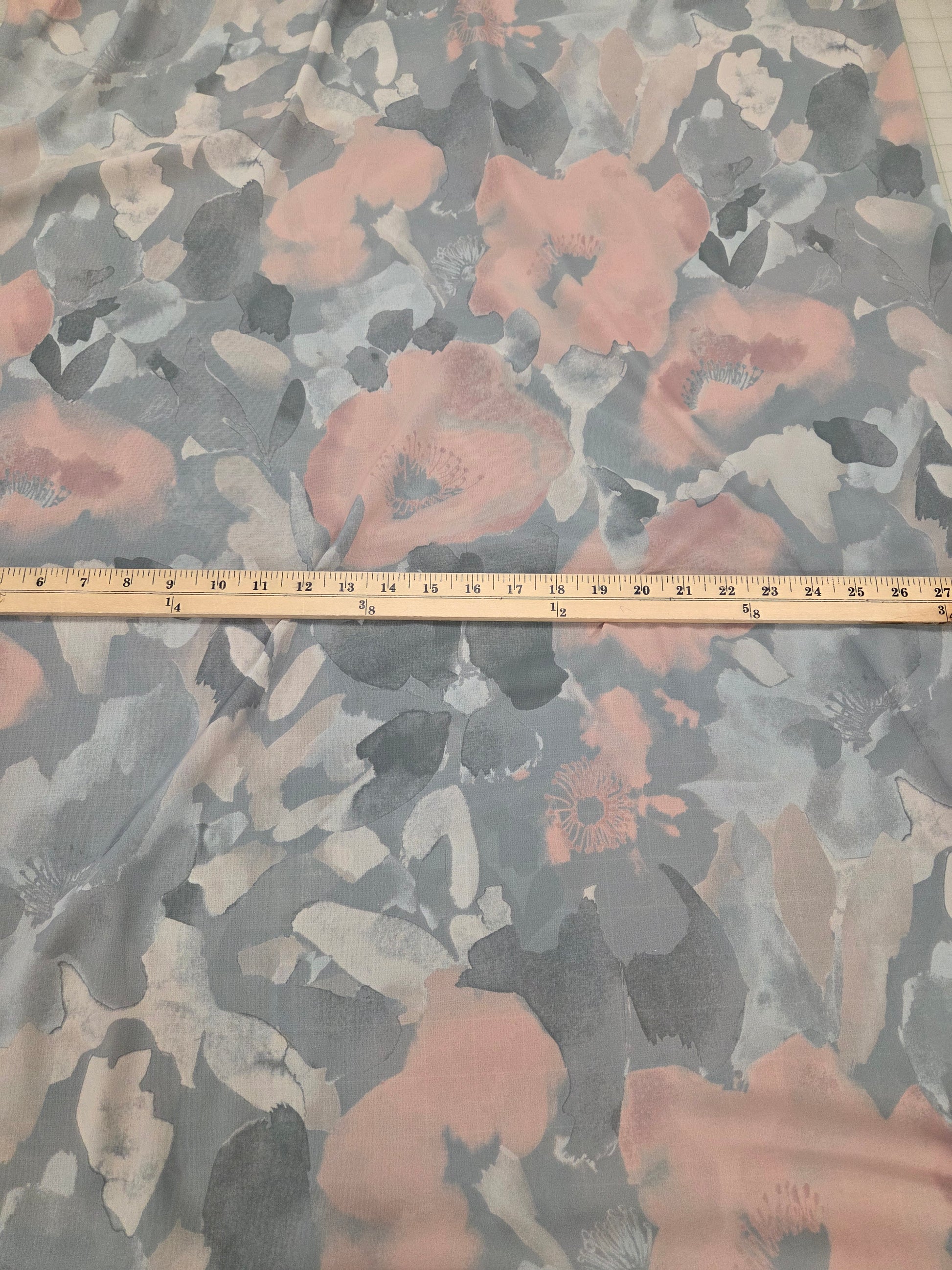 Floral patterned fabric with a ruler for scale on a gray background