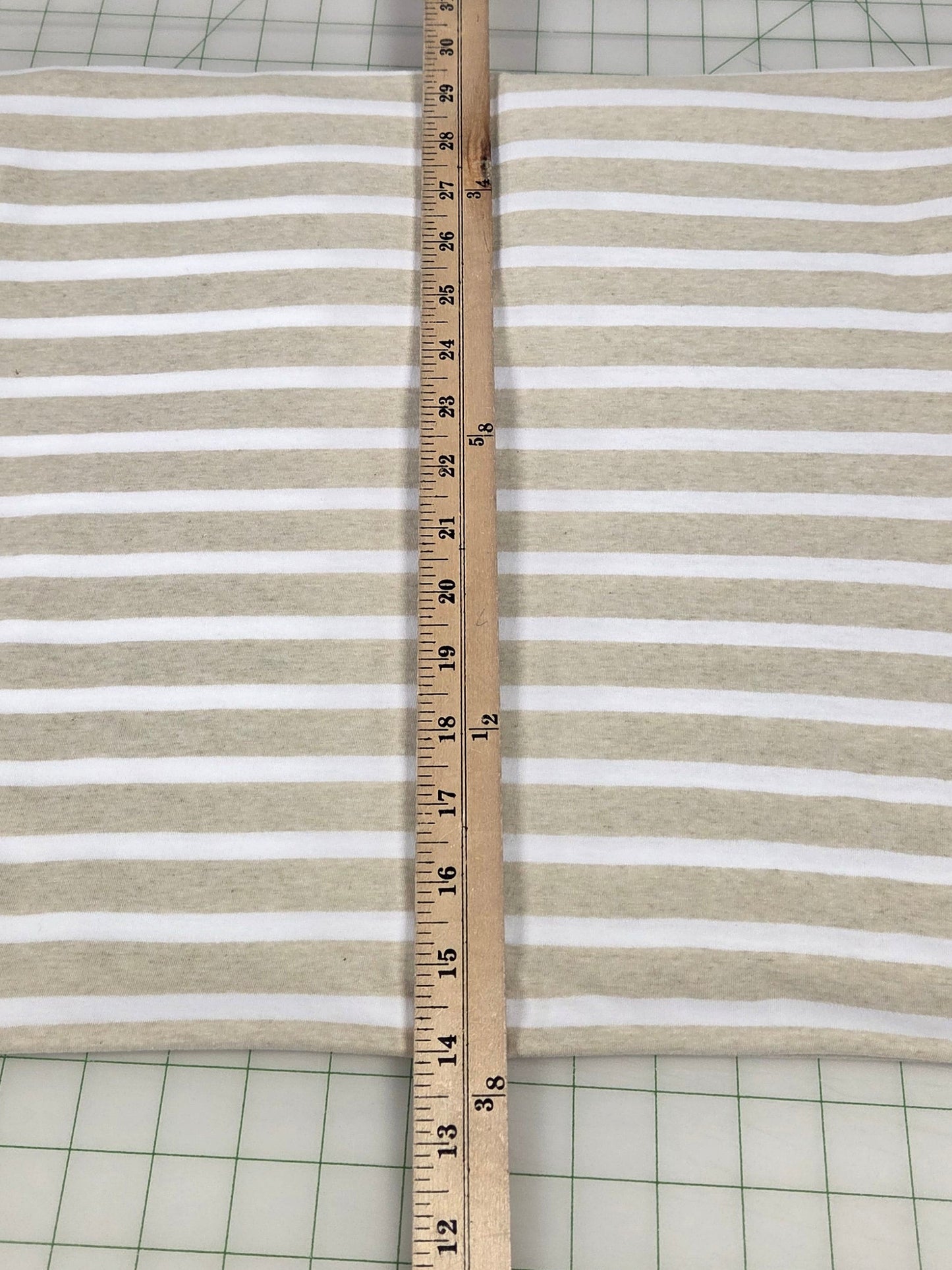 Striped fabric with a ruler for measurement on a grid background