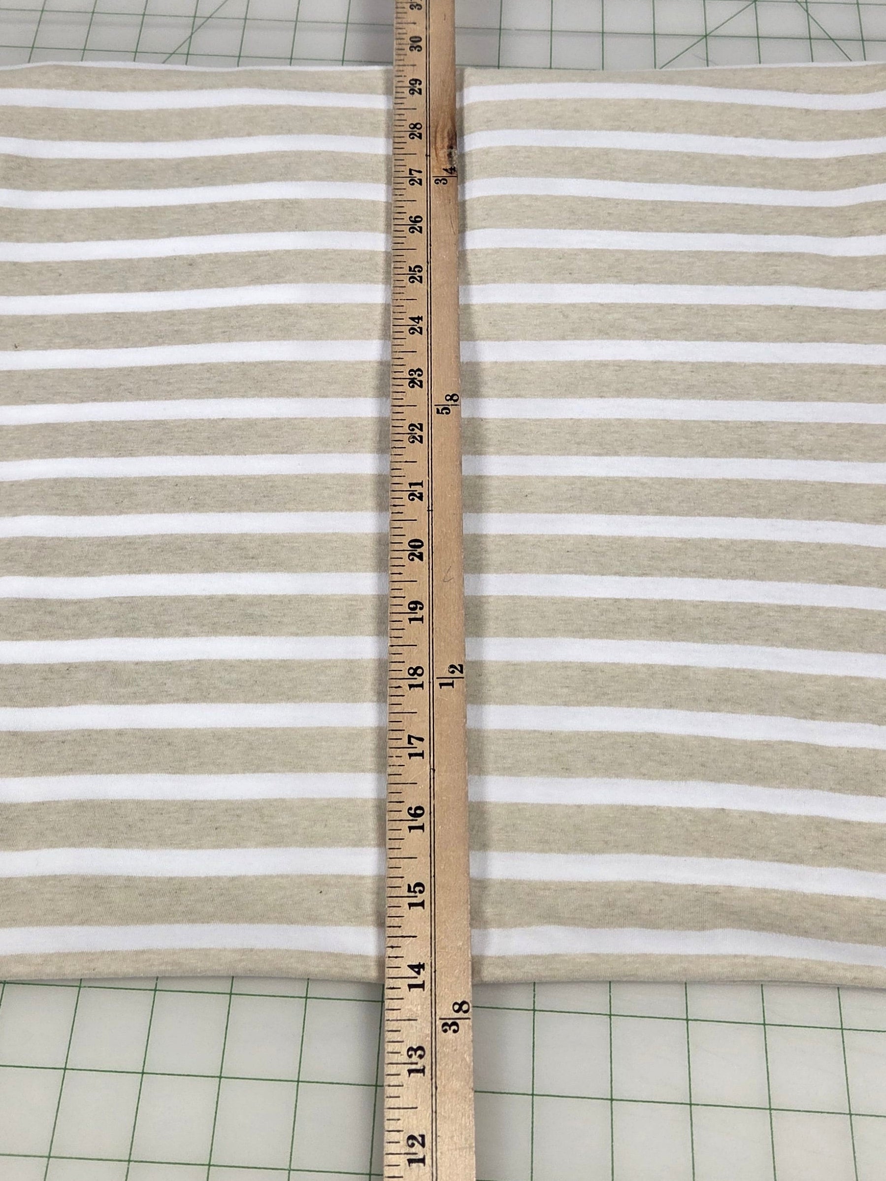 Striped fabric with a ruler for measurement on a grid background