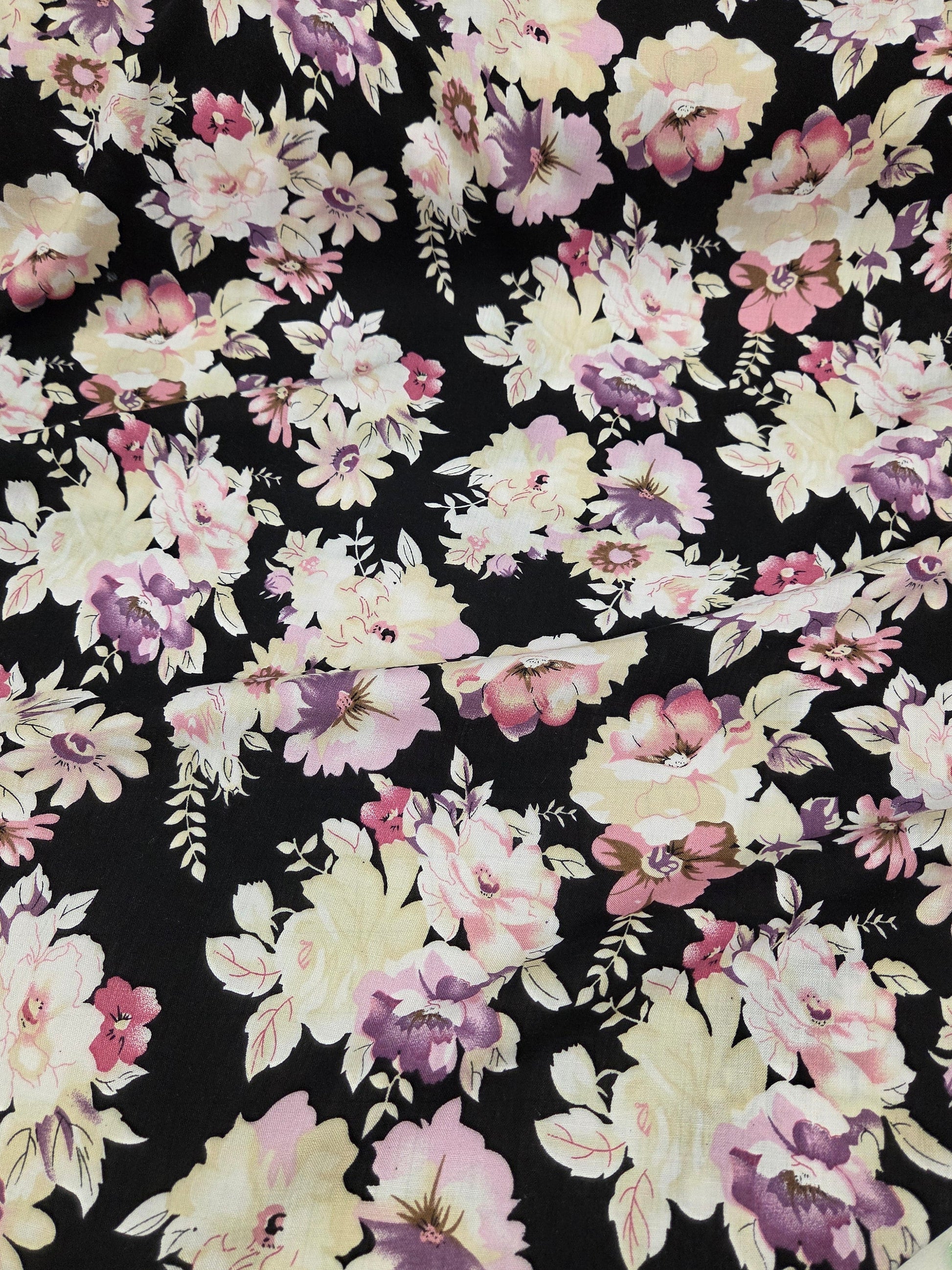 Floral fabric with pink and white flowers on a black background. sophia rose flroal fabric for making garments and sewing your own clothes. fabric by the yard.