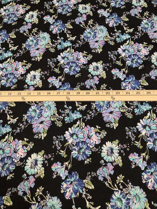 Floral fabric pattern with a ruler for scale on a black background
