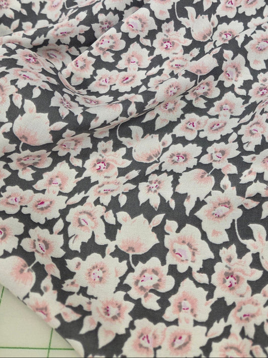 Floral fabric with pink flowers on a dark background