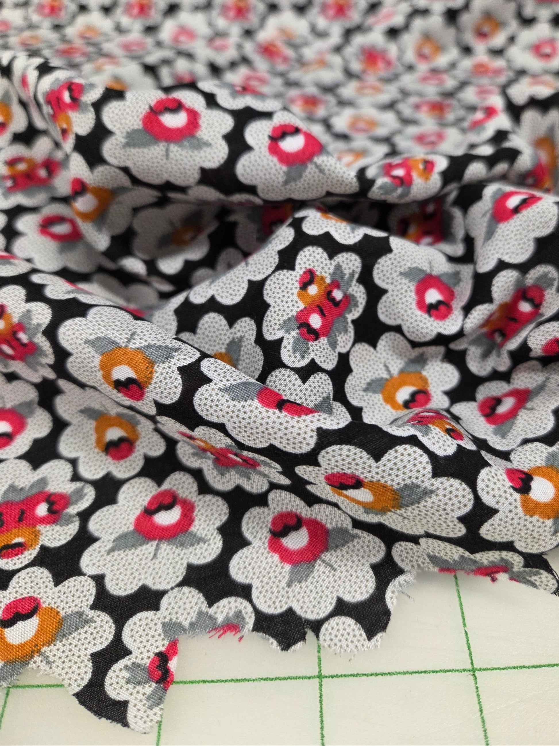 Close-up of floral fabric with a grid background