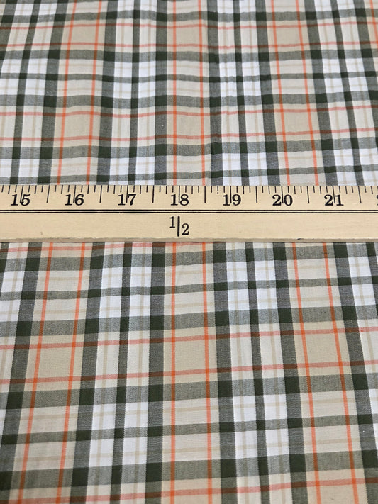 Plaid fabric with a measuring tape indicating measurements