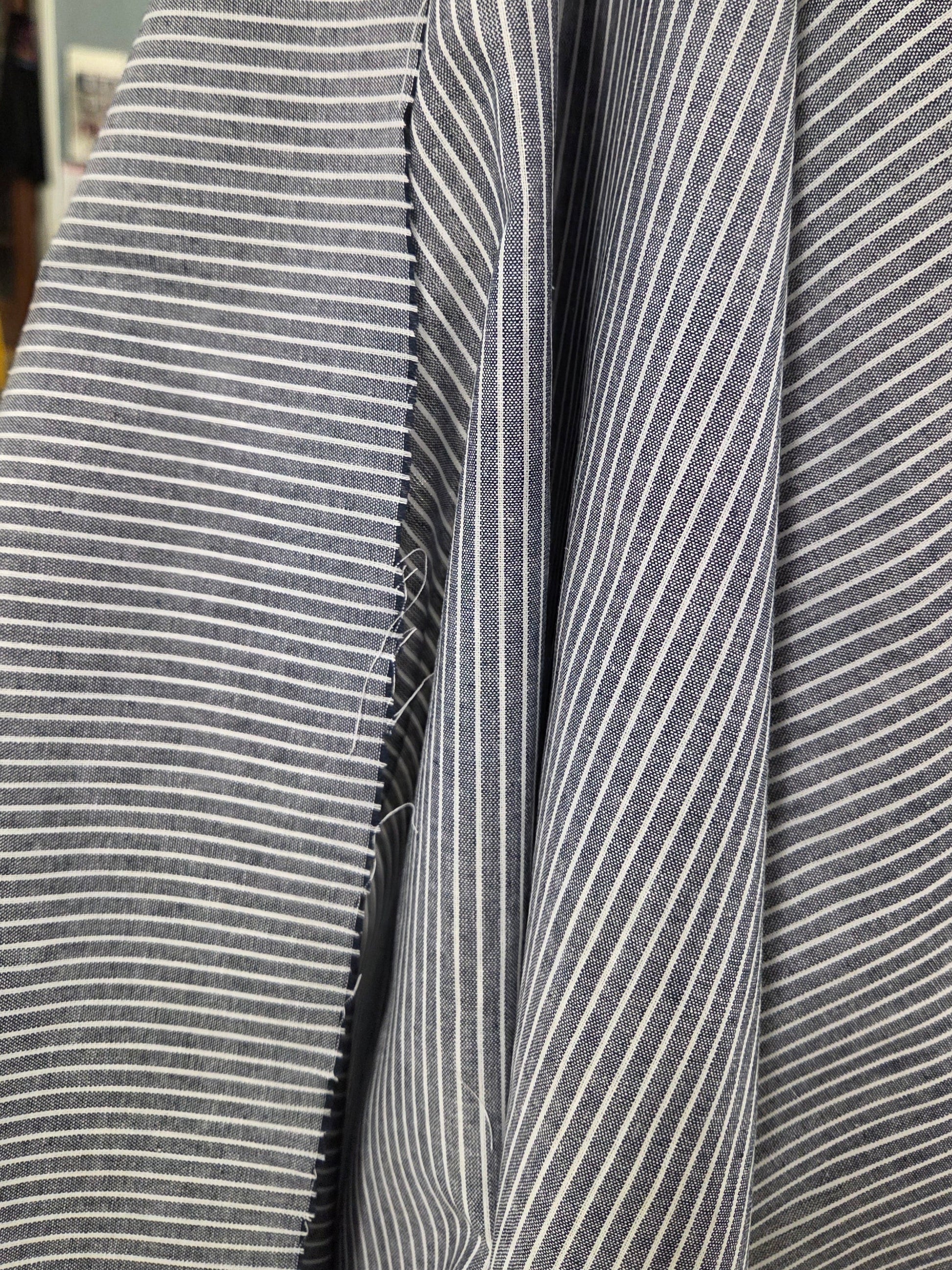 Close-up of gray and white striped fabric with a blurred background