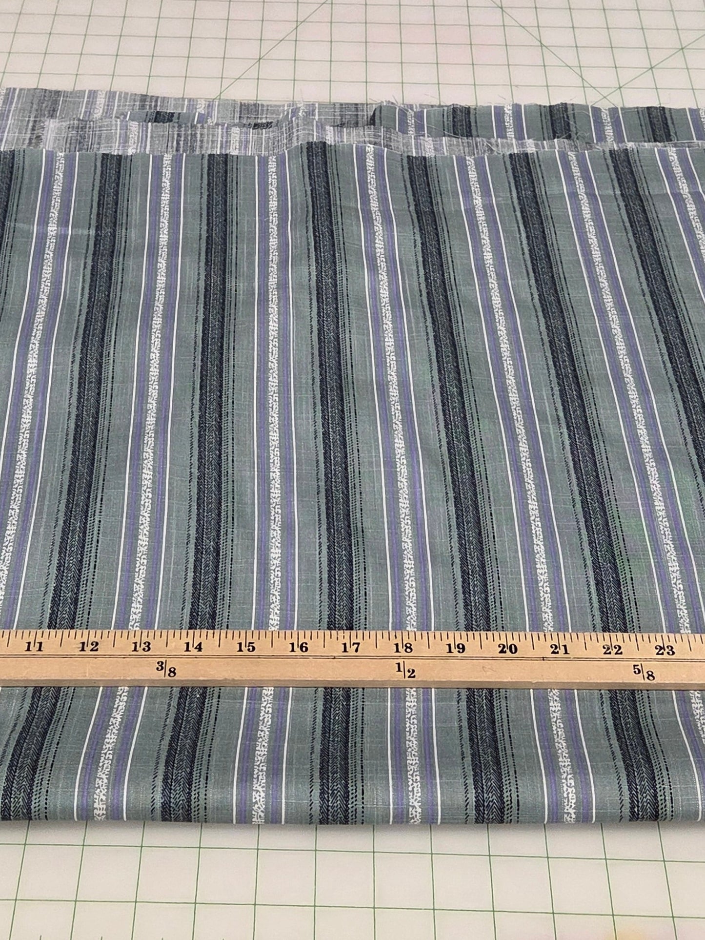 Striped fabric on a cutting mat with a ruler for measurement