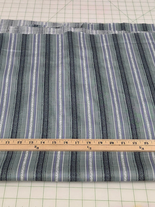 Striped fabric on a cutting mat with a ruler for measurement