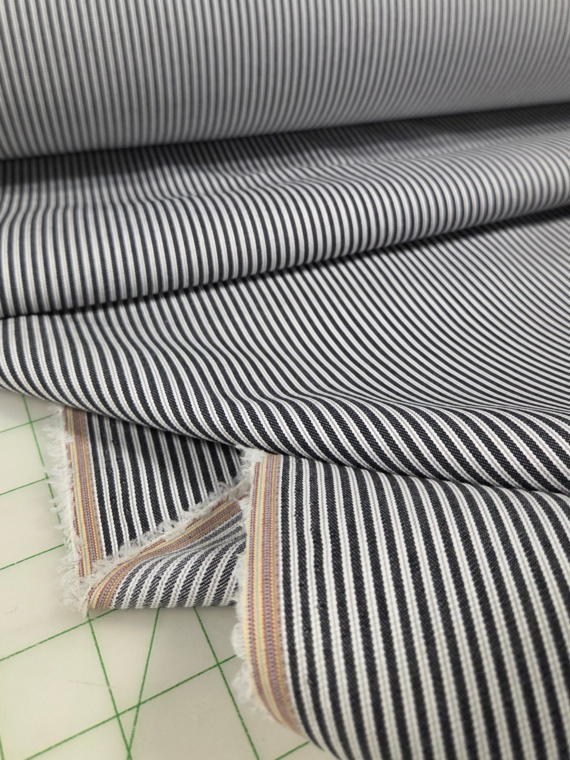 Striped fabric with a grid pattern on a cutting mat